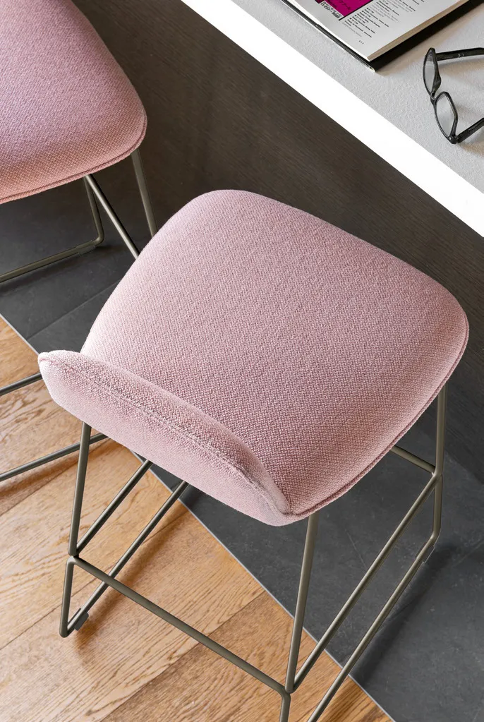 Dettaglio della scocca imbottita rosa dello sgabello Riley Soft Connubia sulla struttura a slitta