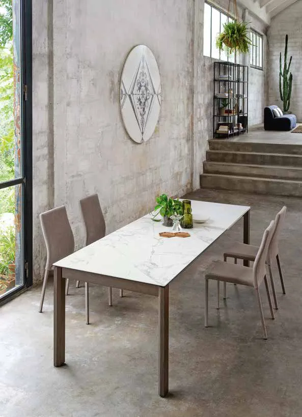 Tavolo Leon Friulsedie aperto con piano Keramic Invisible White in un ambiente con scala