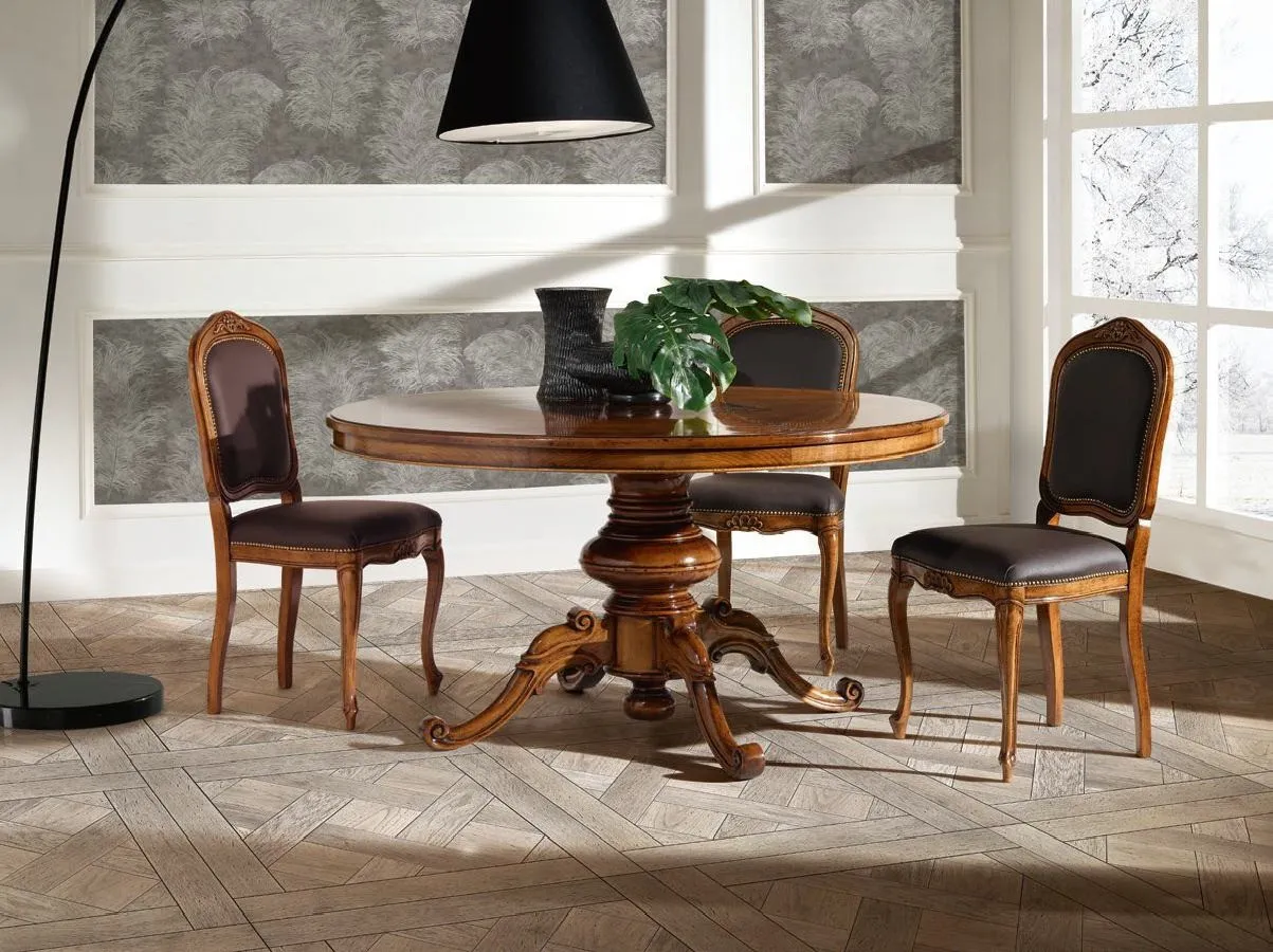 Tavolo rotondo Trend Style Imba in noce con gambone centrale e sedie imbottite nere