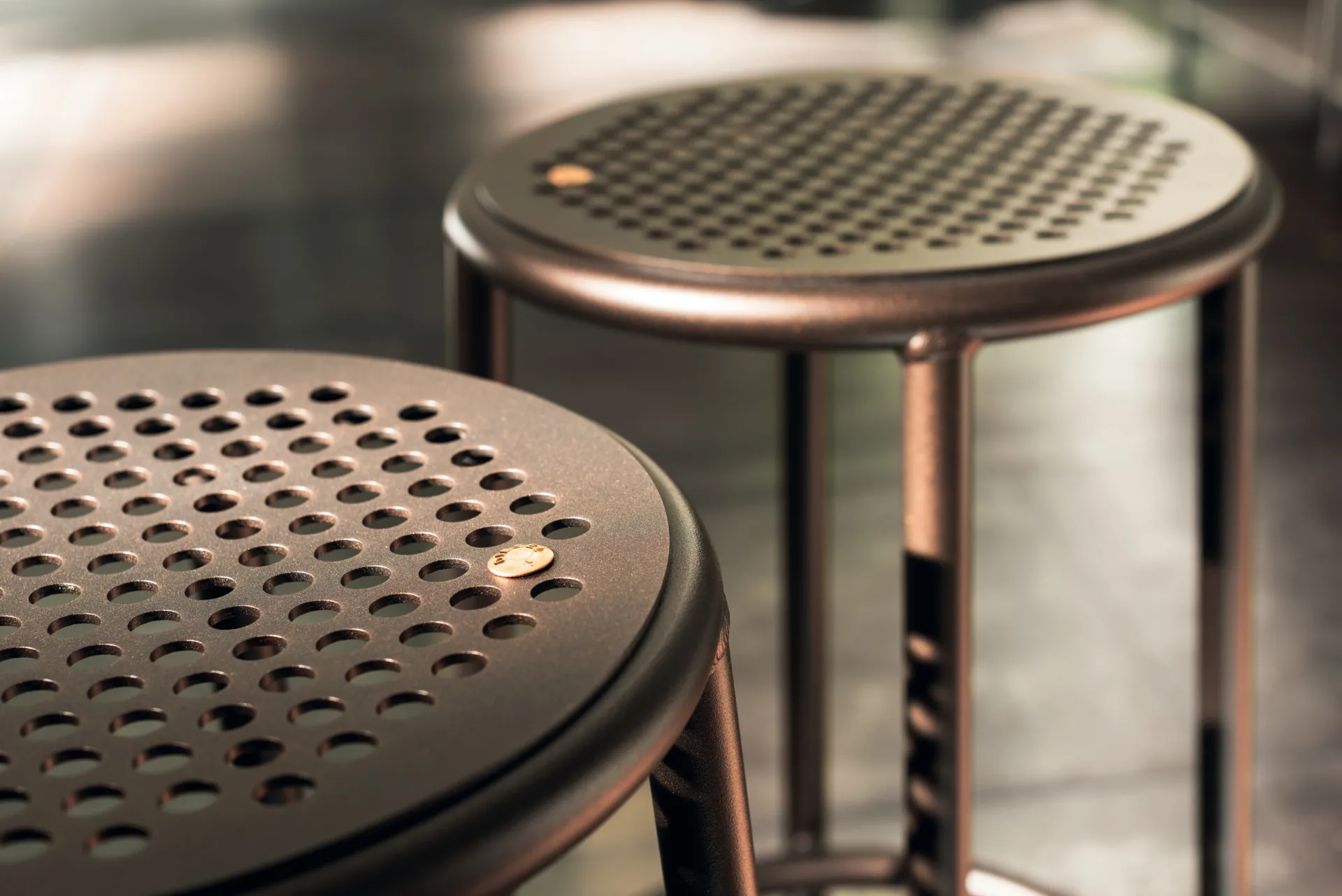 Dettaglio della seduta forata color rame dello sgabello Nizza Scavolini