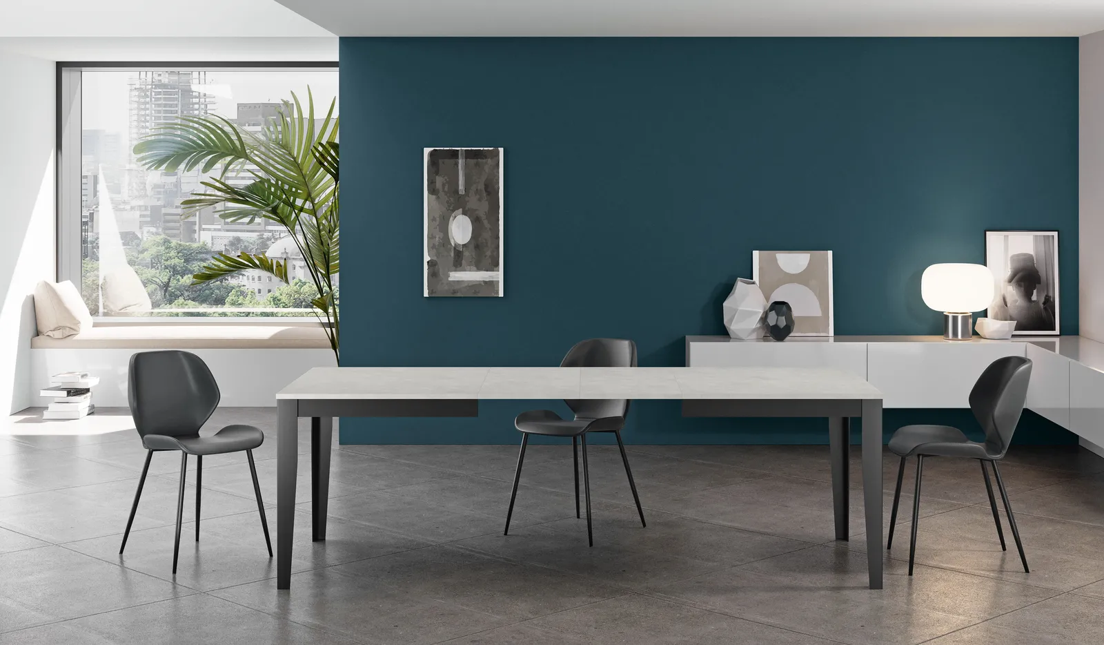 Tavolo Big Stones cemento bianco con base nera in una sala da pranzo