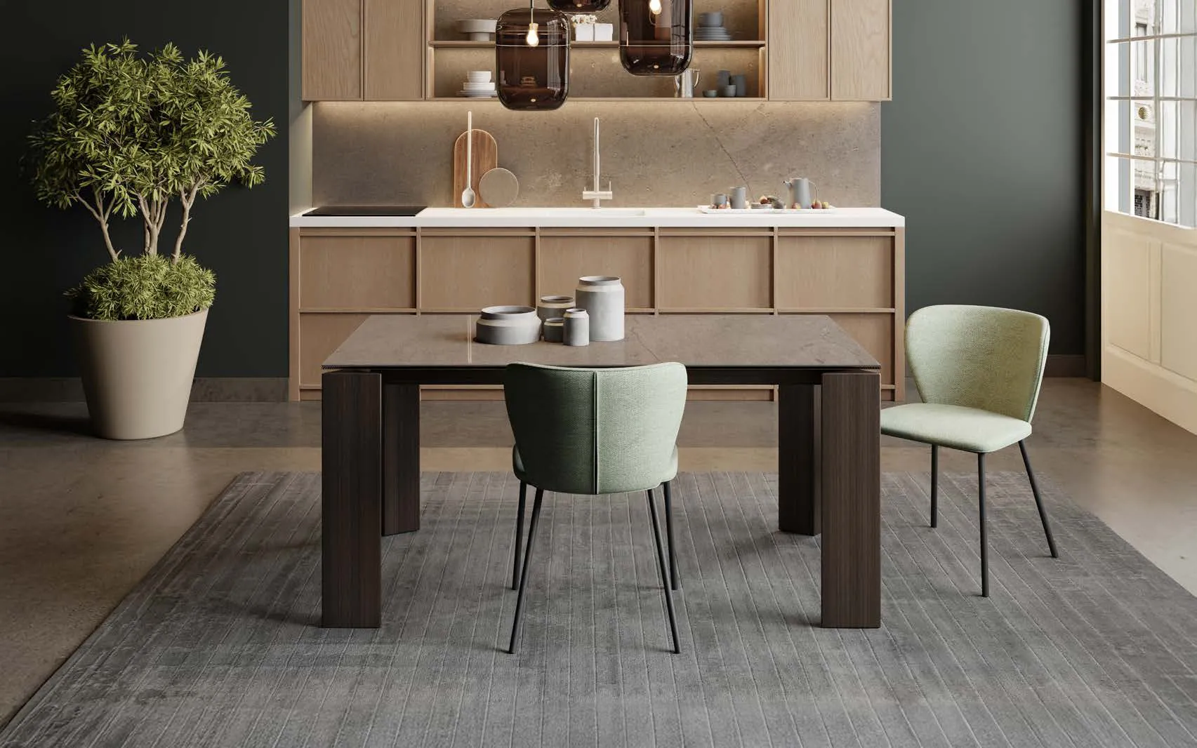 Tavolo Alì fisso Zamagna con piano pietra grey davanti a una cucina in legno