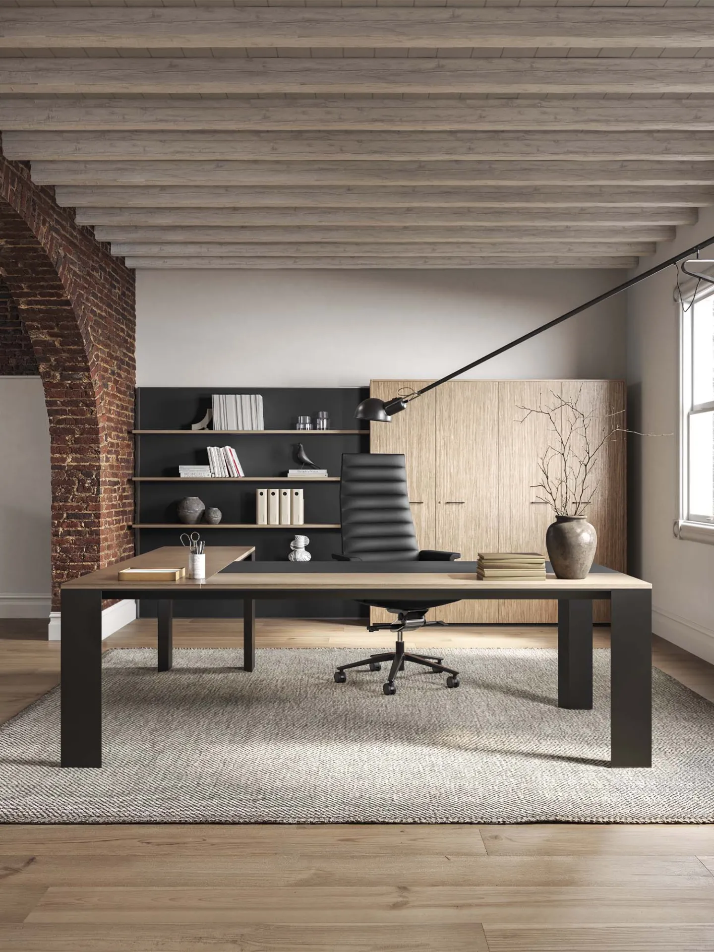 Scrivania Ono Frezza con piano scuro e libreria sullo sfondo