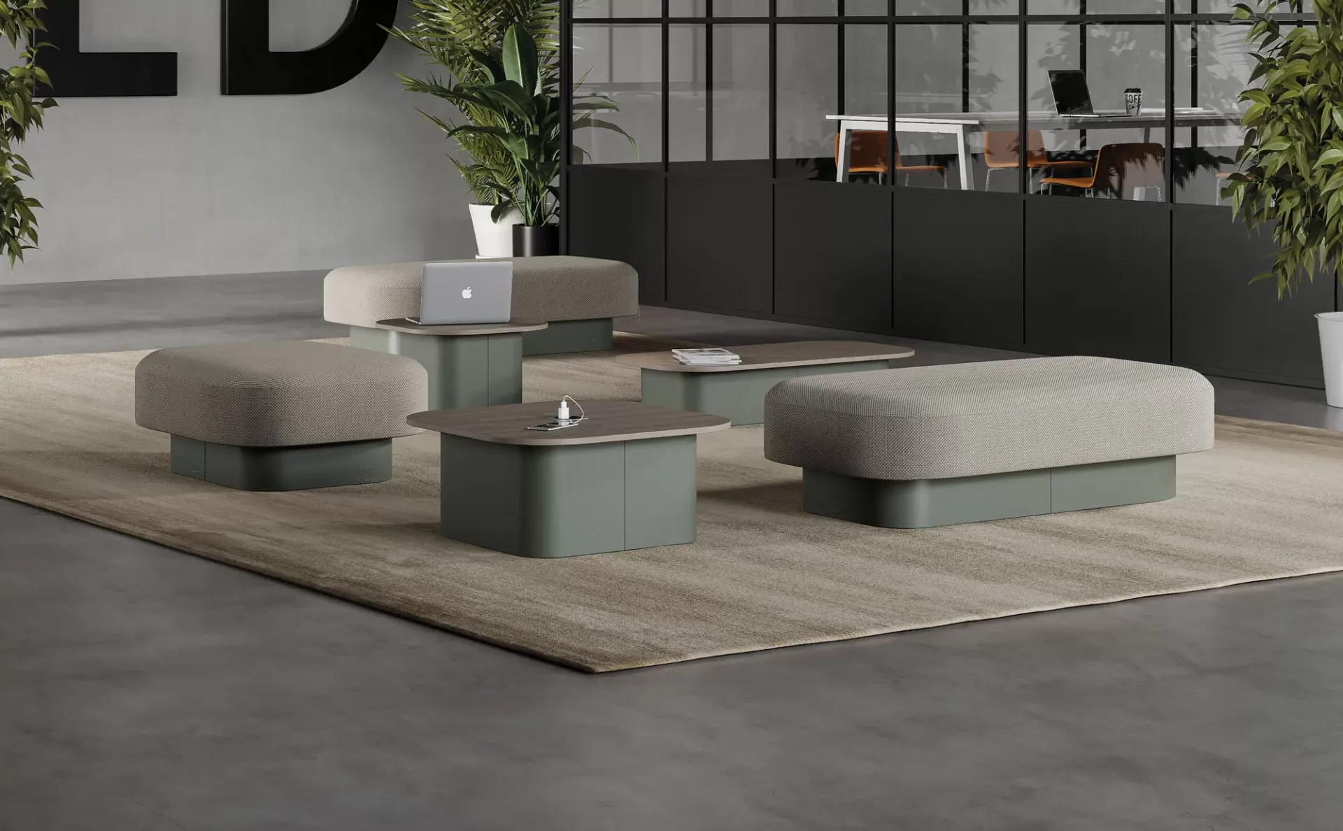 Pouf Afina Frezza grigi accanto a tavolini verdi in un loft