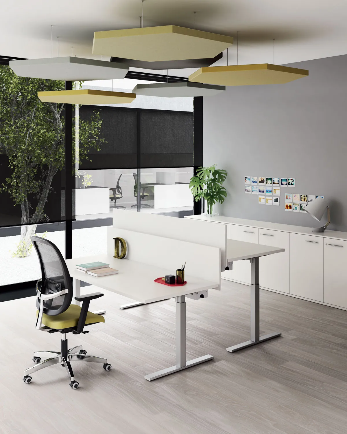 Scrivania Pop Tee Frezza con sedia verde sotto pannelli acustici sospesi