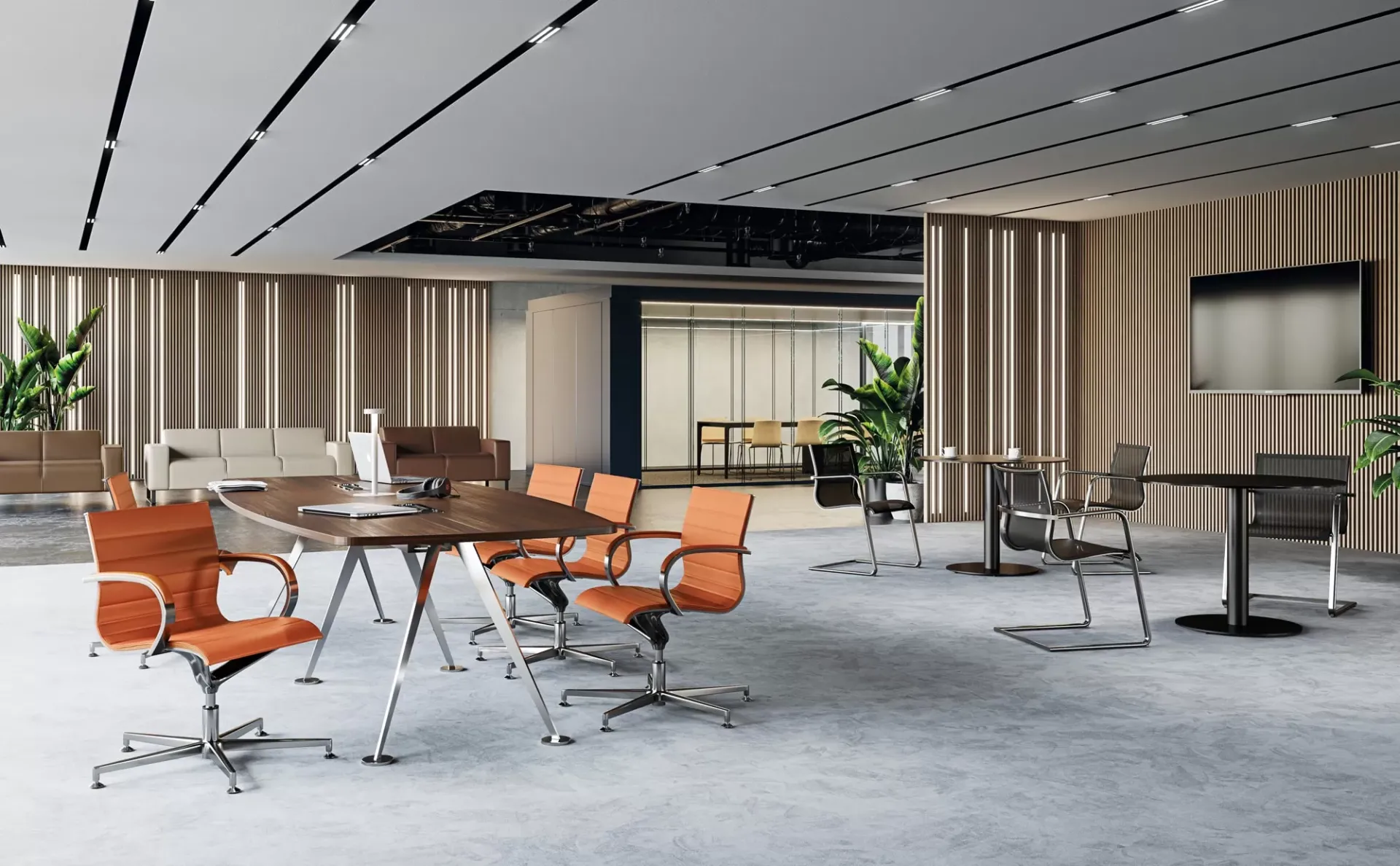 Sedie EM 202 Frezza arancio attorno a un tavolo riunione in un ampio open space