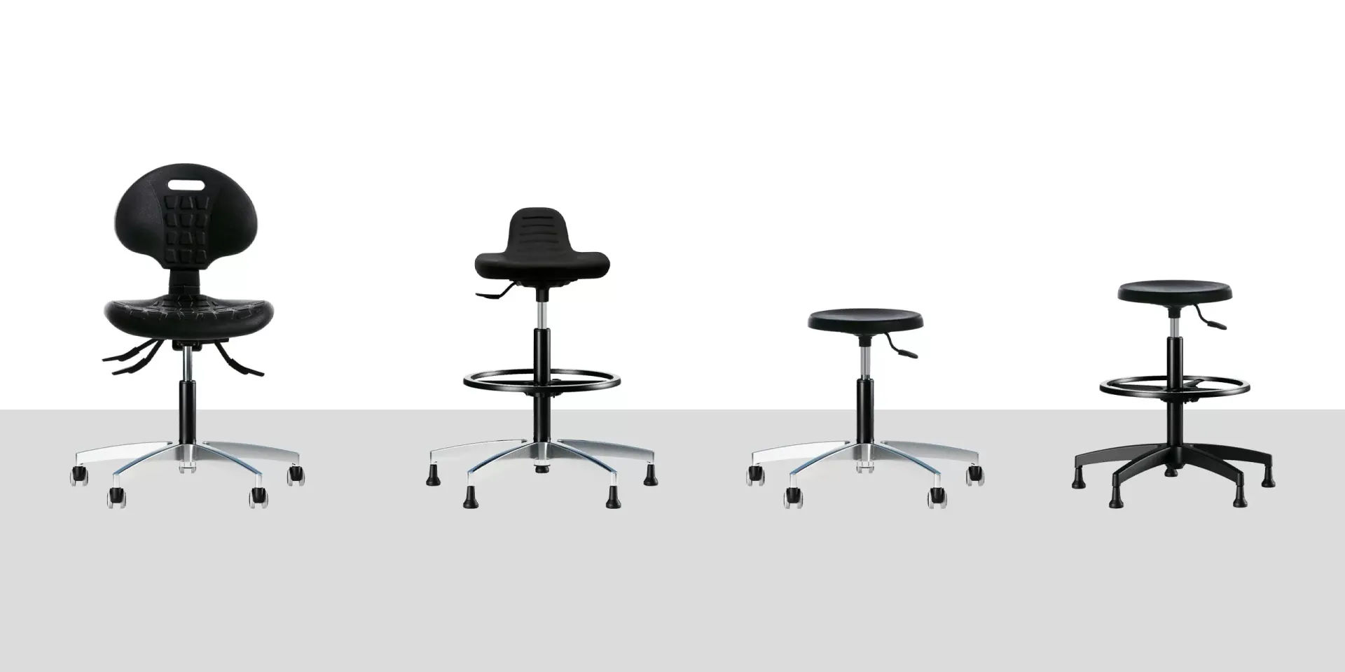 Quattro sedute Ergotech PU Frezza nere: poltroncina, sgabello alto e due sgabelli a tondello
