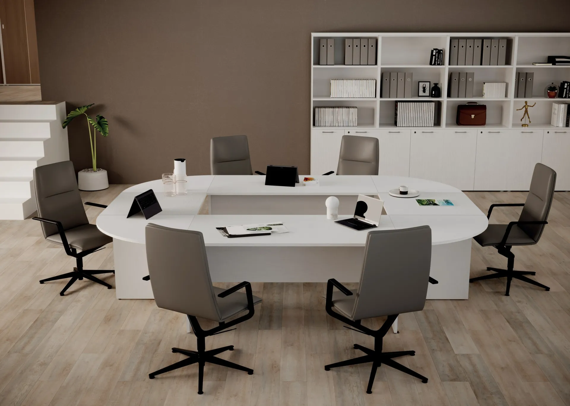 Sala riunioni Ibisco Imba con scrivanie unite a ovale e sedie grigie