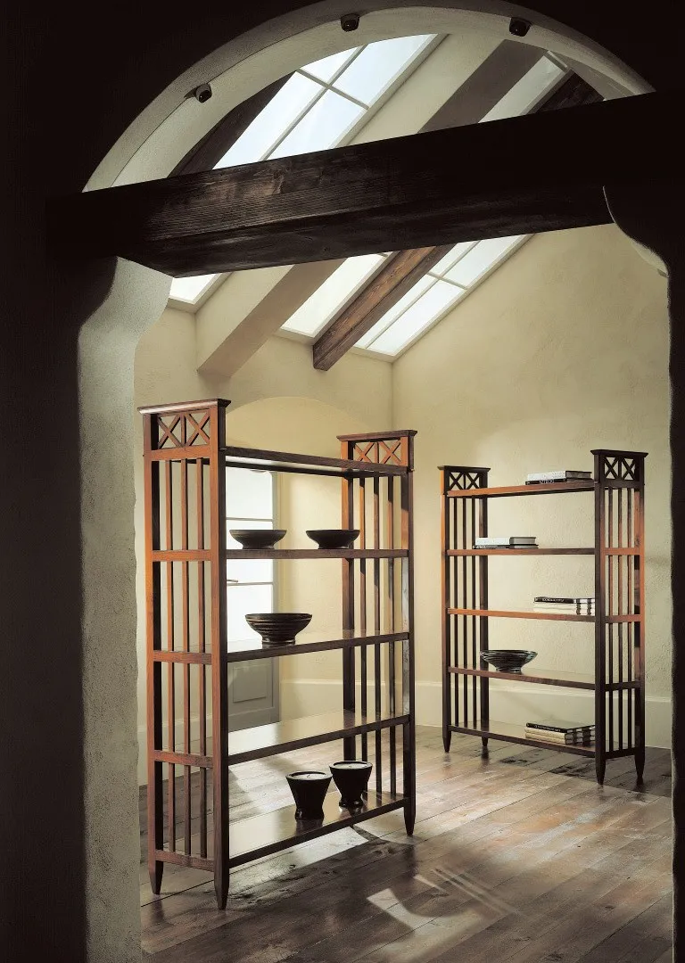 Libreria bifacciale Ottocento Avenanti in ciliegio sotto un arco, con vasi sui ripiani