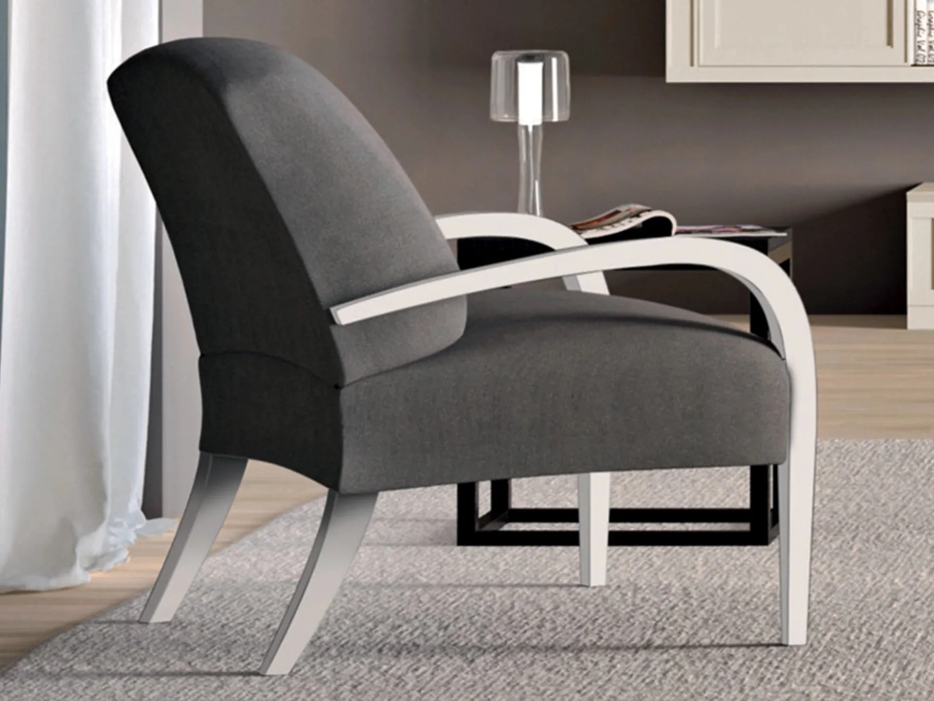 Poltroncina Suite Le Fablier rivestita in tessuto grigio scuro con braccioli bianchi