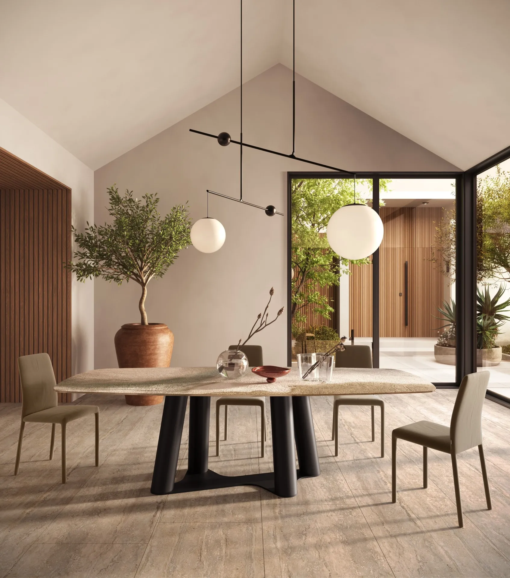 Tavolo Singapore Scavolini ovale chiaro sotto lampade a sfera in un ambiente con tetto a falde