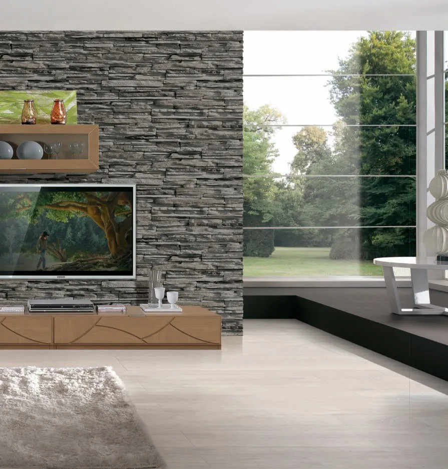 Parete soggiorno House Project Imba con base bassa e mensole davanti a un muro in pietra