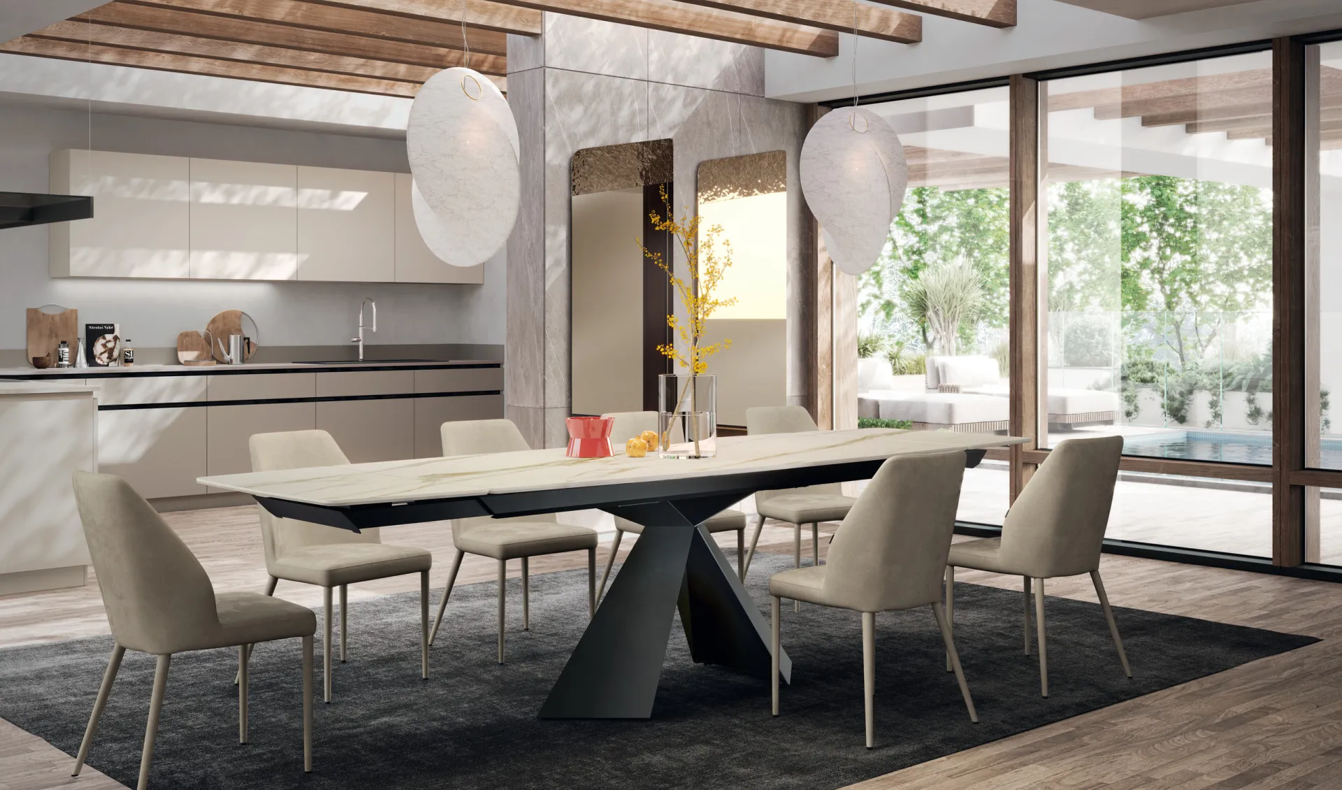 Tavolo Metropolis Scavolini allungato con piano chiaro effetto marmo e base geometrica scura accanto alla cucina