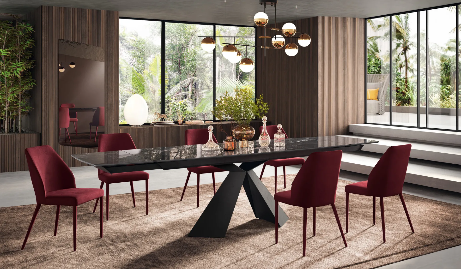 Tavolo Metropolis Scavolini con piano scuro, base a lastre triangolari e sedie rosse