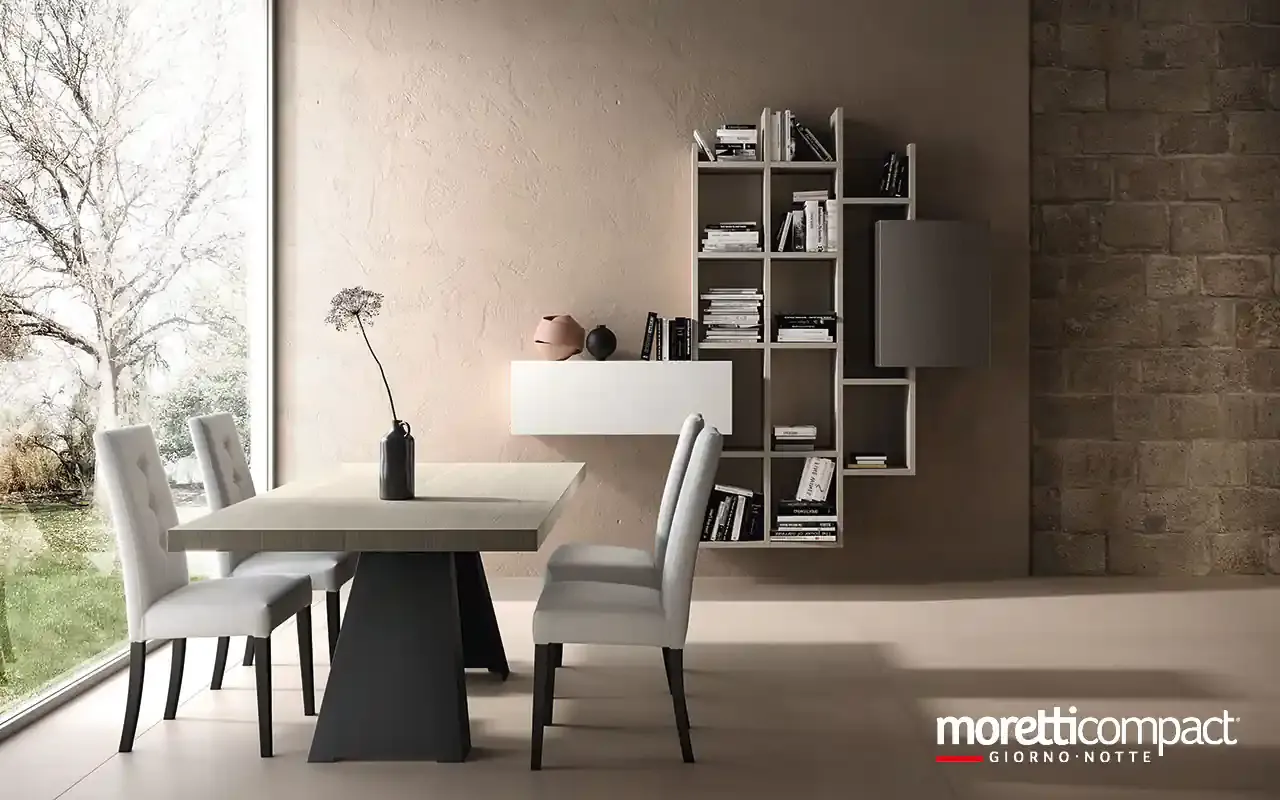 Libreria pensile Kosmos KC107B Moretti Compact a vani aperti accanto a un tavolo da pranzo