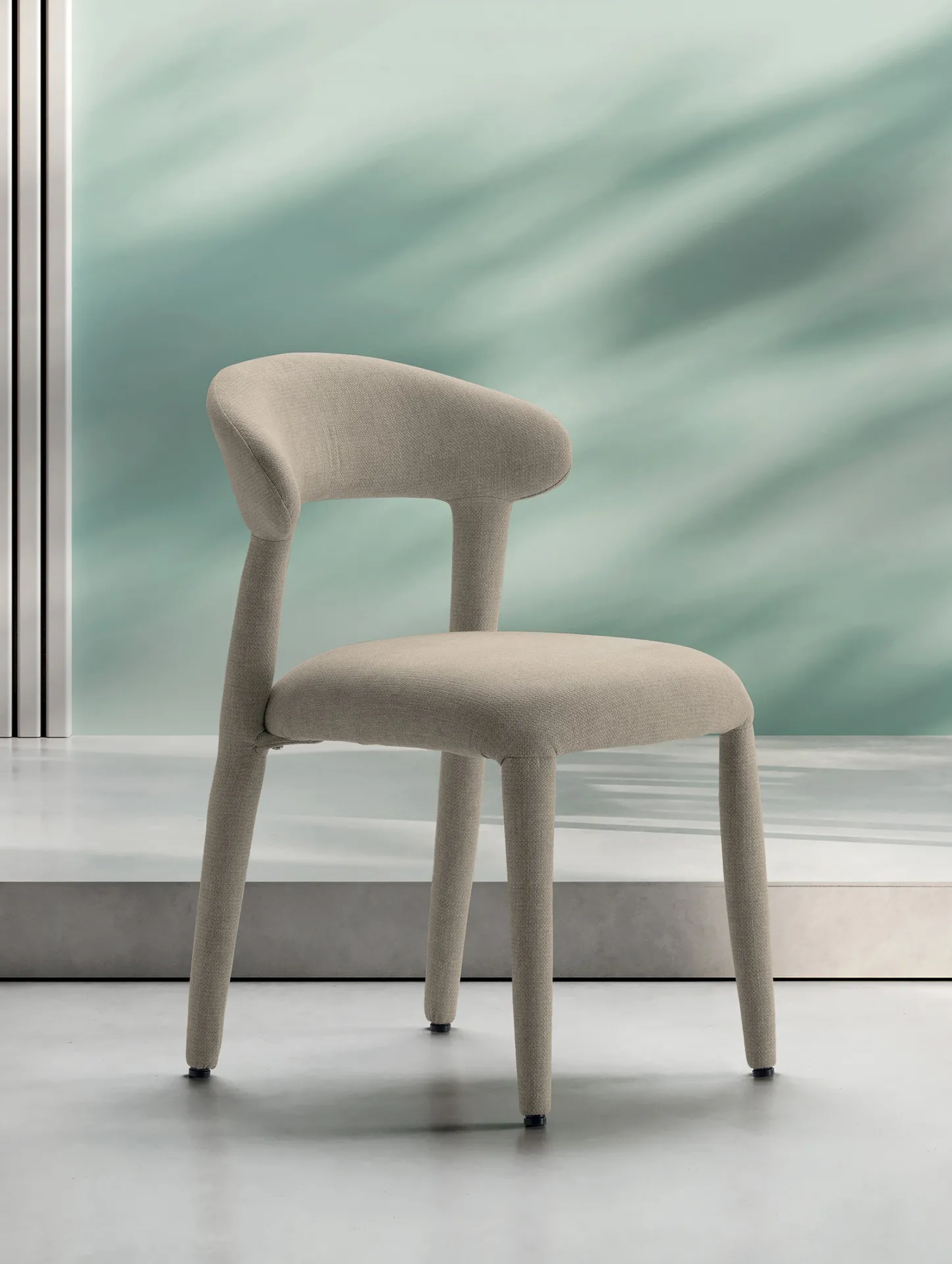 Sedia Livia Stones beige vista di tre quarti su uno sfondo verde acqua
