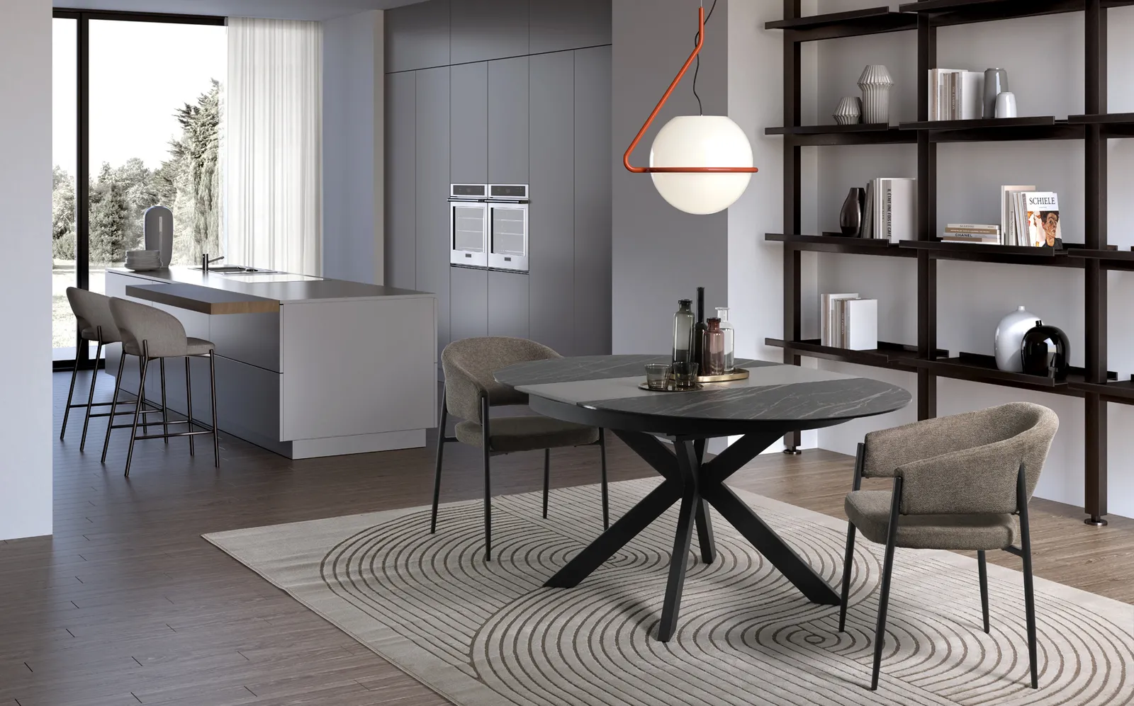 Tavolo rotondo Moon Stones in Portoro nero con base incrociata antracite in un open space con cucina