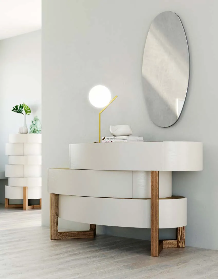 Cassettone Eclisse Fazzini con specchio ovale e settimino ellittico sullo sfondo
