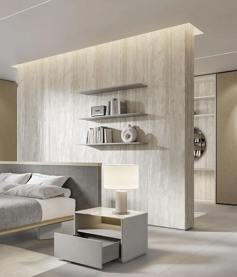 Comodino Nodus MobilGam accanto al letto davanti a boiserie travertino