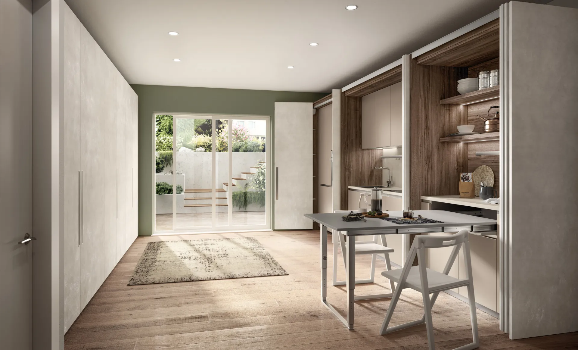 Sistema BoxLife Scavolini aperto, con cucina, mensole e tavolo con sedie pieghevoli in un ambiente stretto