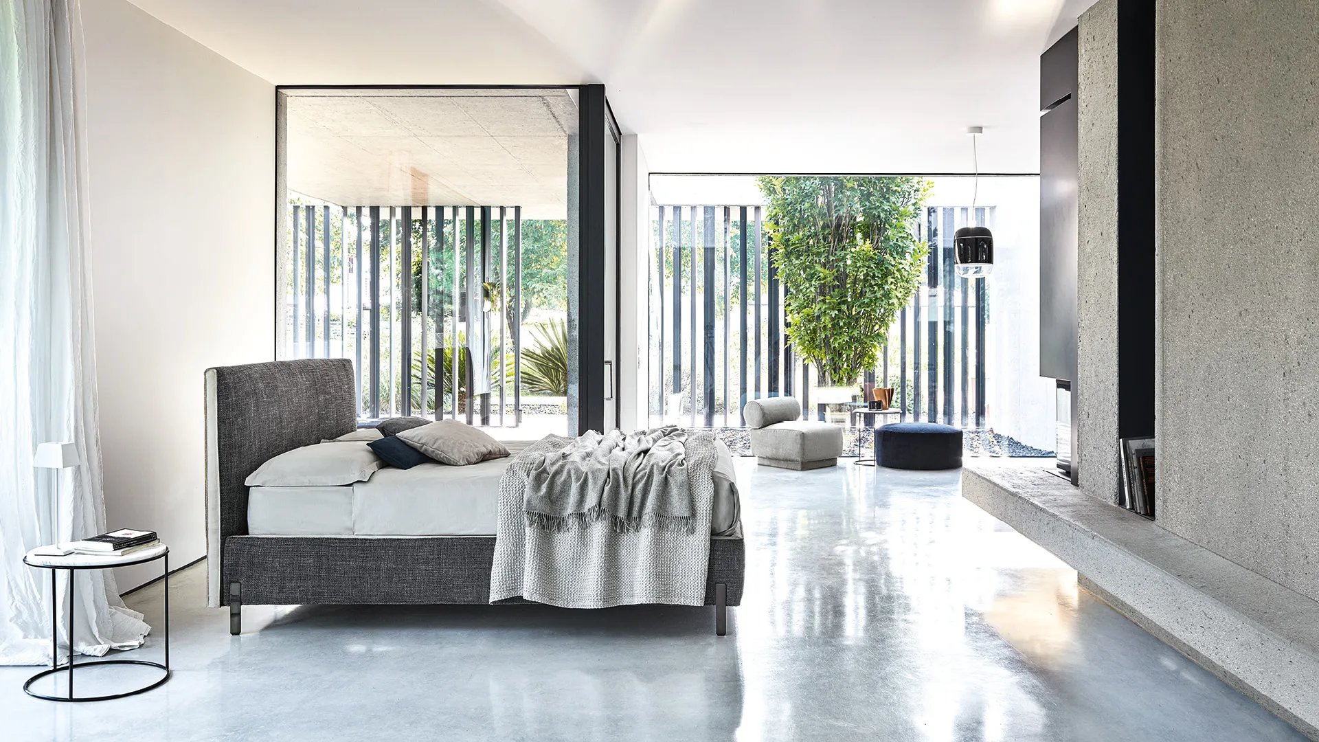 Letto Poseidone Rosini grigio in un ambiente con vetrate