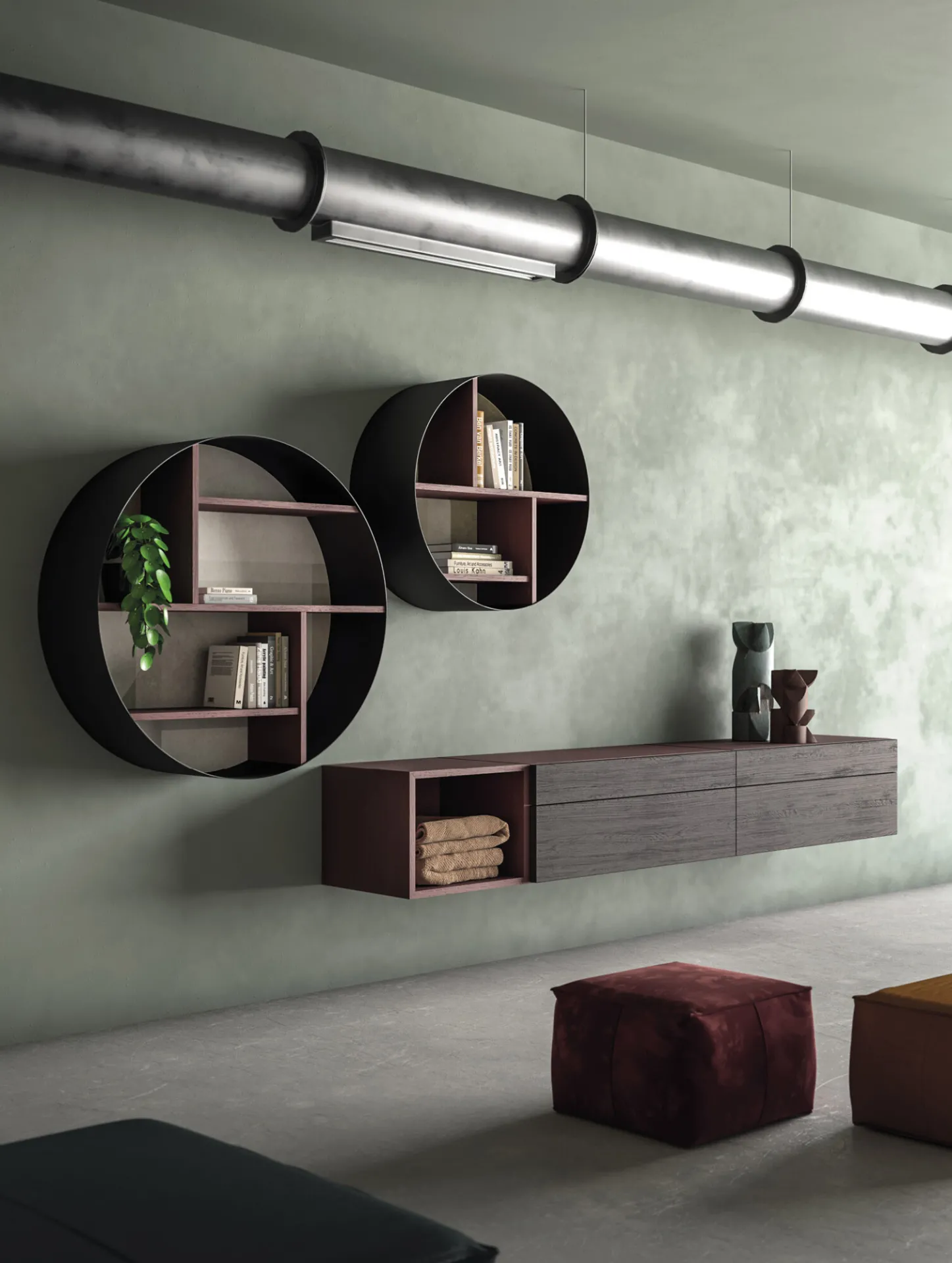 Due librerie rotonde Icons 360° Devina Nais appese sopra una base sospesa, su parete verde