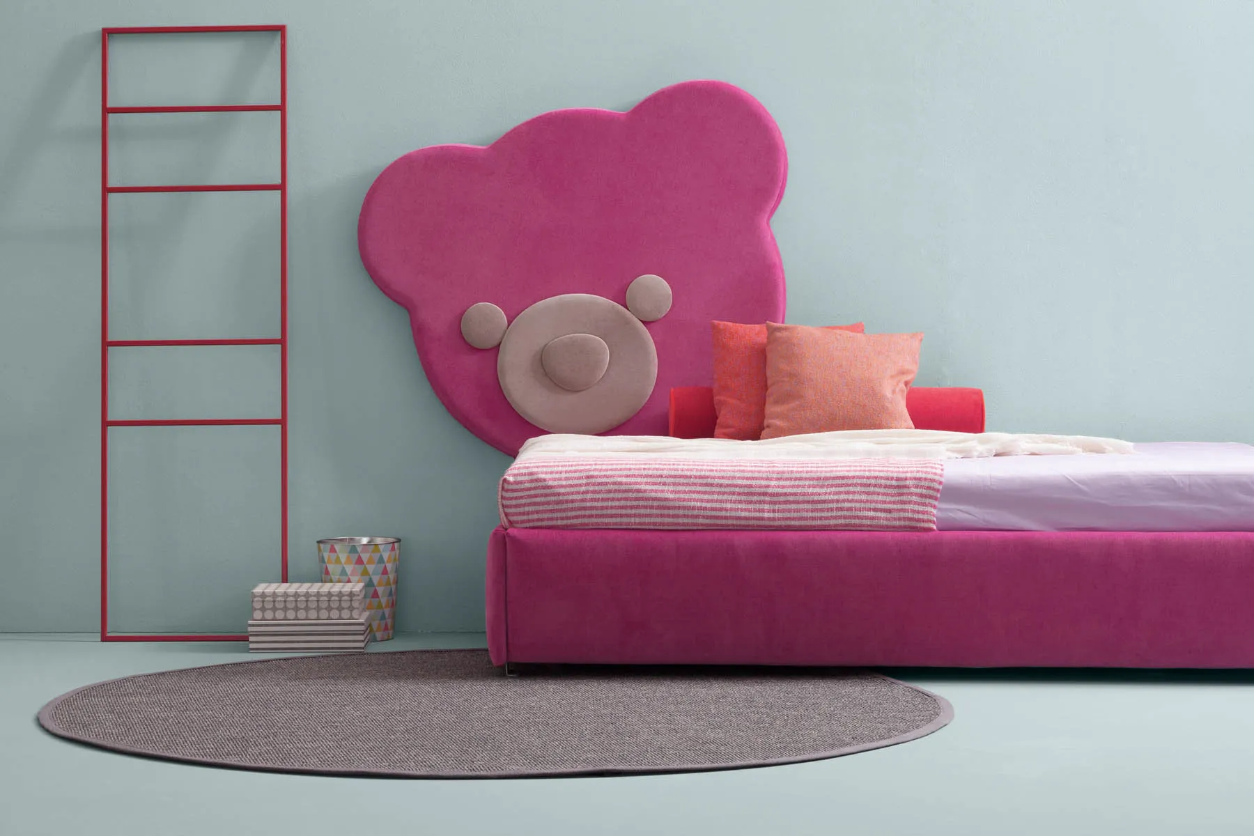 Pannello Ted Samoa fucsia dietro un letto singolo rosa, accanto a una scala rossa