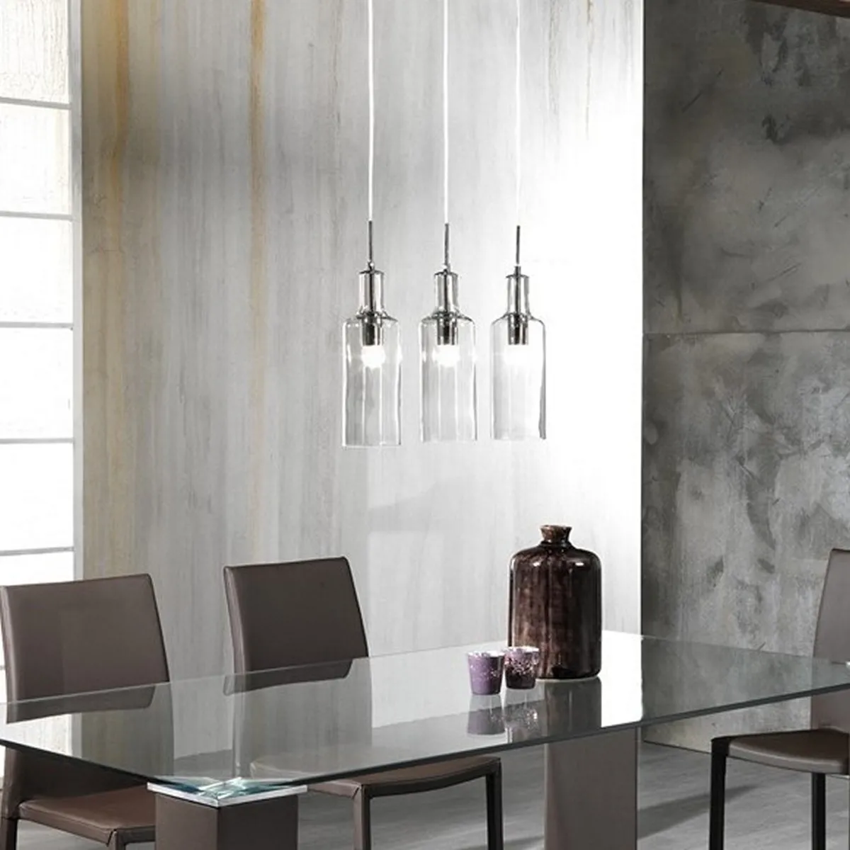 Lampadario Bottles Tomasucci a 3 luci trasparenti sopra un tavolo