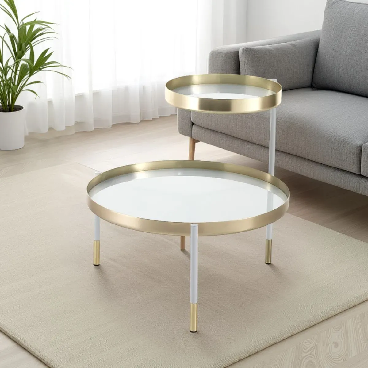 Tavolino Lincoln Tomasucci oro e bianco con piani girevoli accanto al divano
