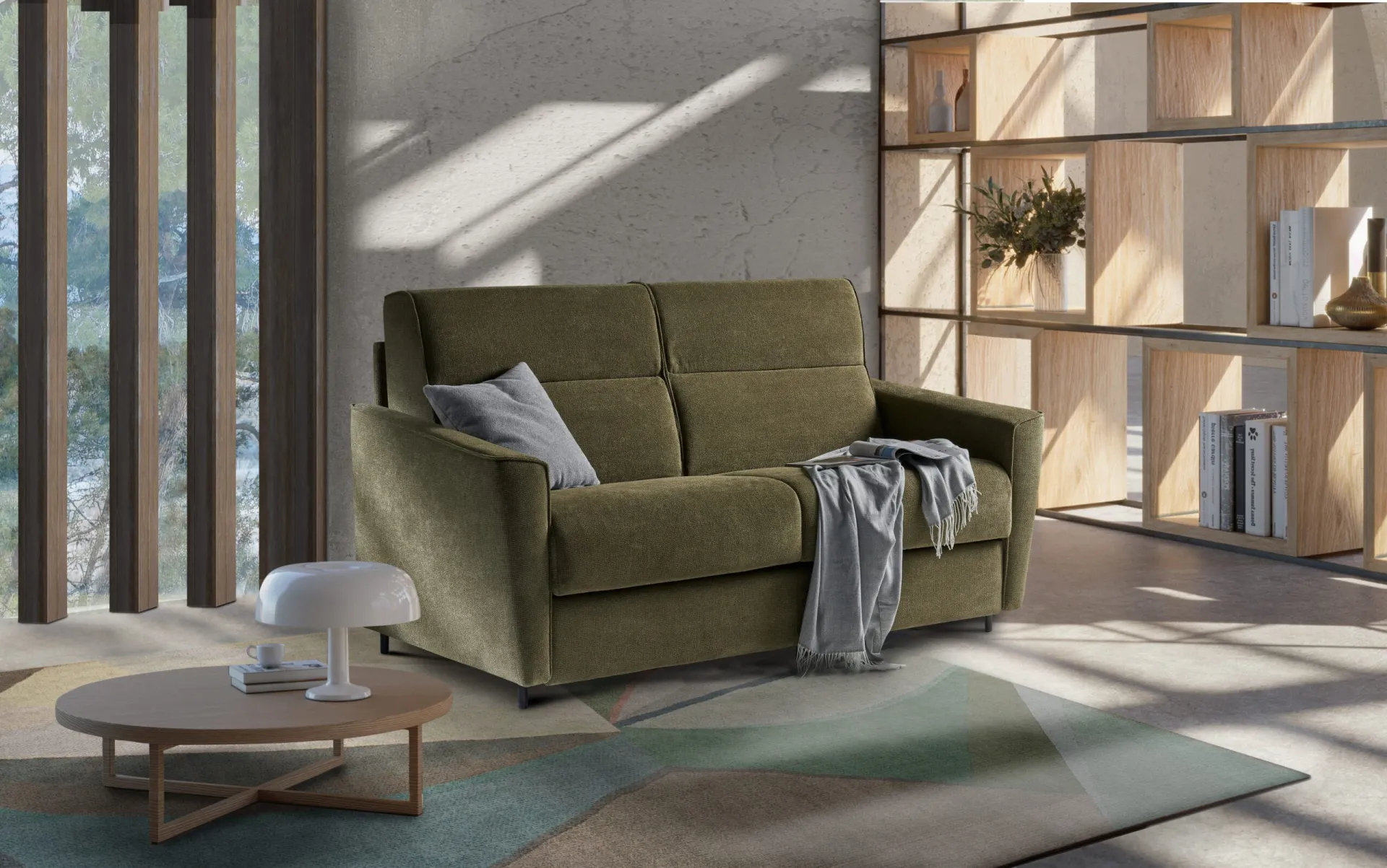 Divano letto Bingo Il Benessere verde oliva in un soggiorno con libreria