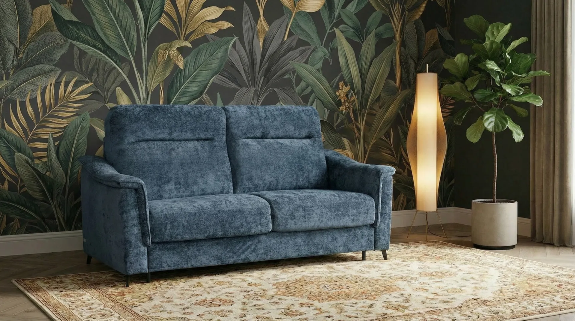 Divano Brooklyn Il Benessere blu davanti a una parete con foglie tropicali