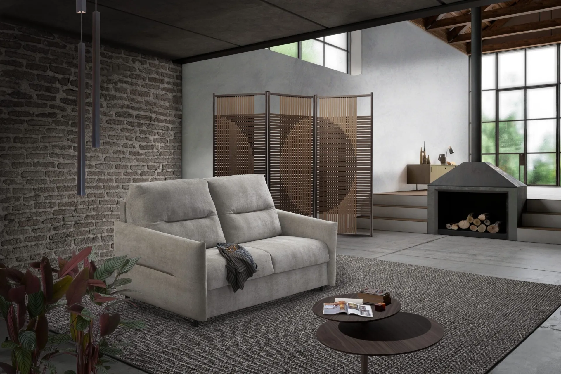 Divano letto Eolo Il Benessere grigio chiaro in un loft con muro in mattoni