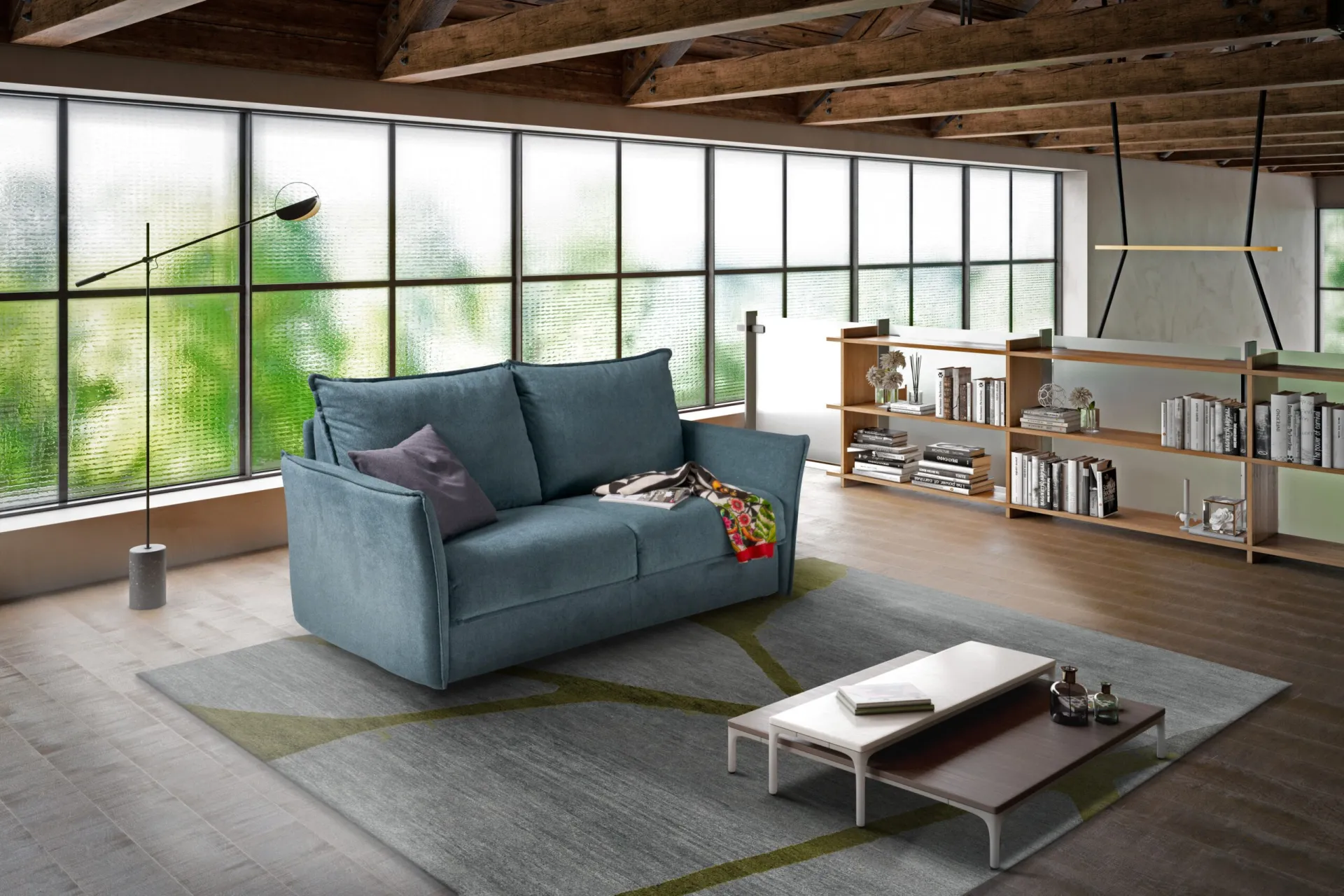 Divano letto Mojito Il Benessere azzurro in un loft con vetrate e libreria