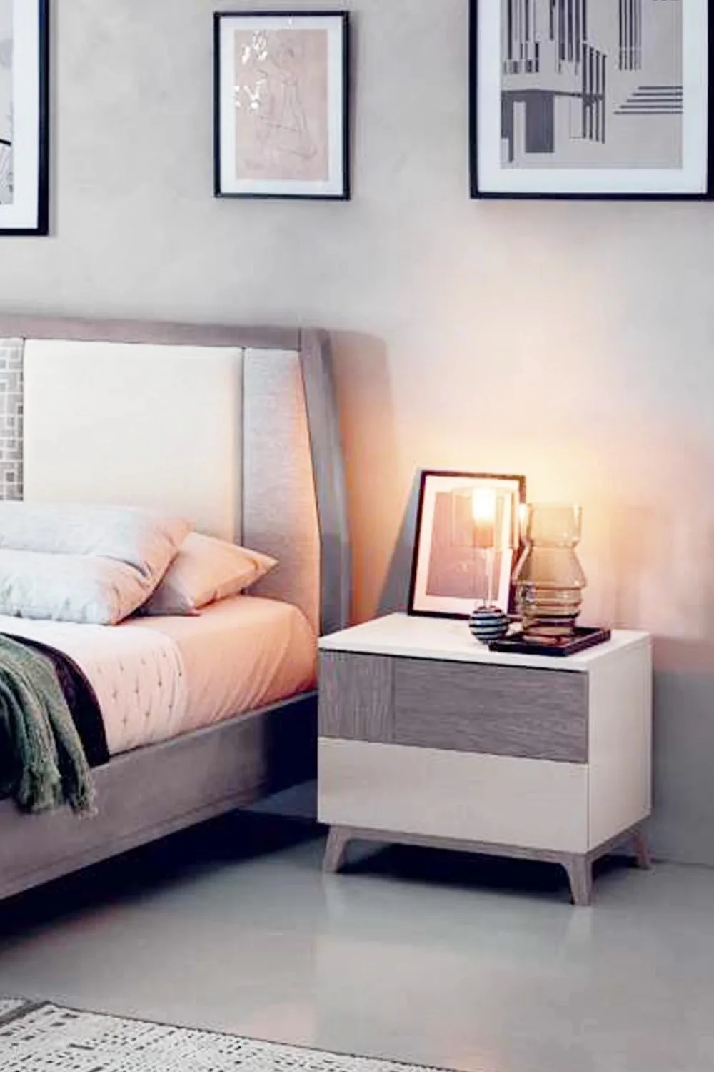 Comodino Citronella Le Fablier accanto al letto con una lampada accesa