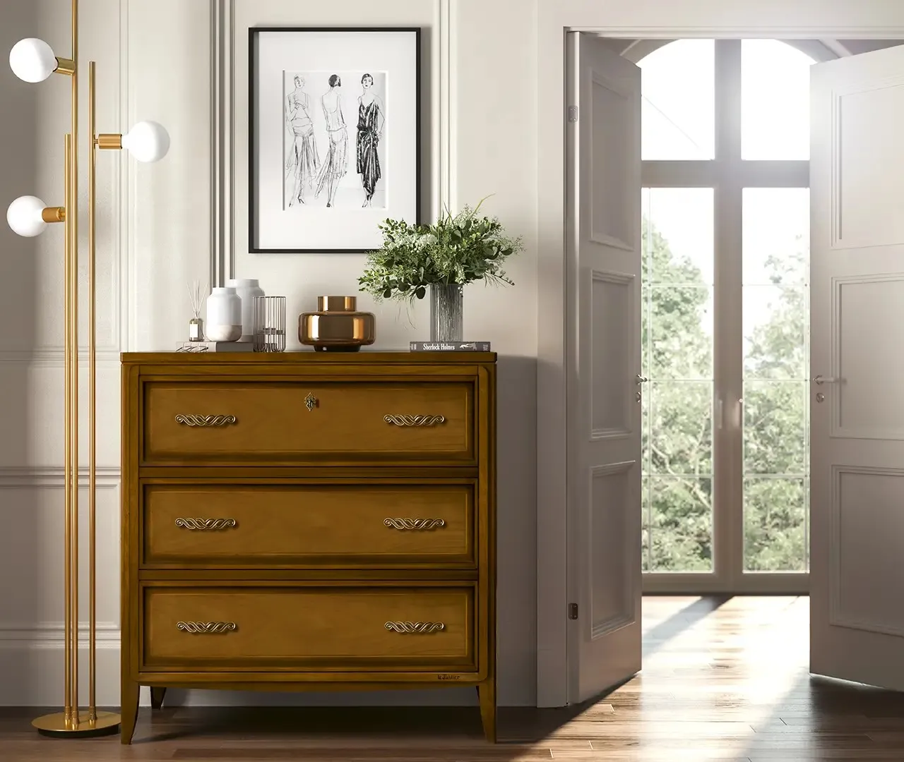 Comò Scrigno Le Fablier in legno a tre cassetti sotto una stampa incorniciata