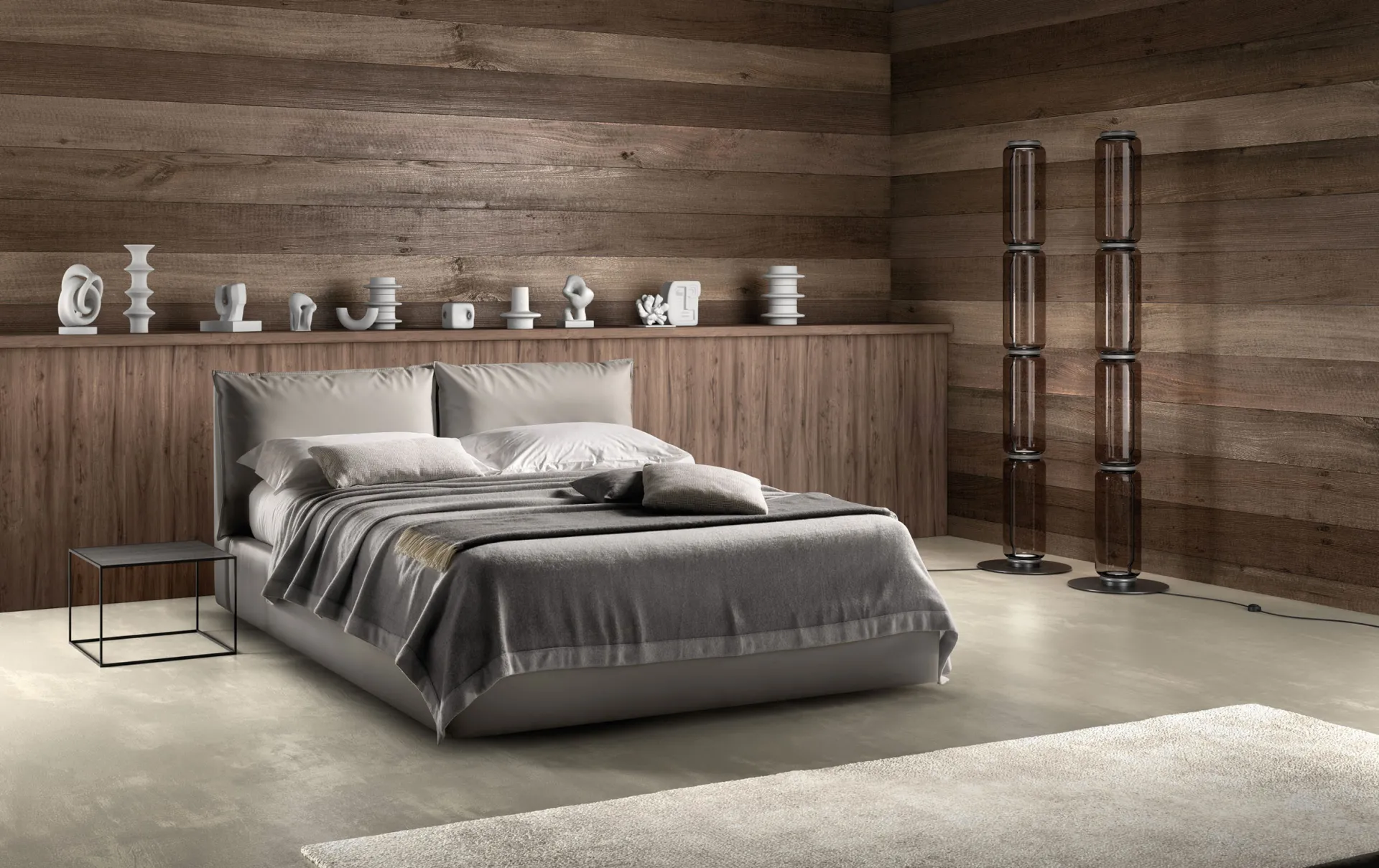 Letto imbottito Quiet Samoa tortora con due grandi cuscini, in una camera con pareti in legno