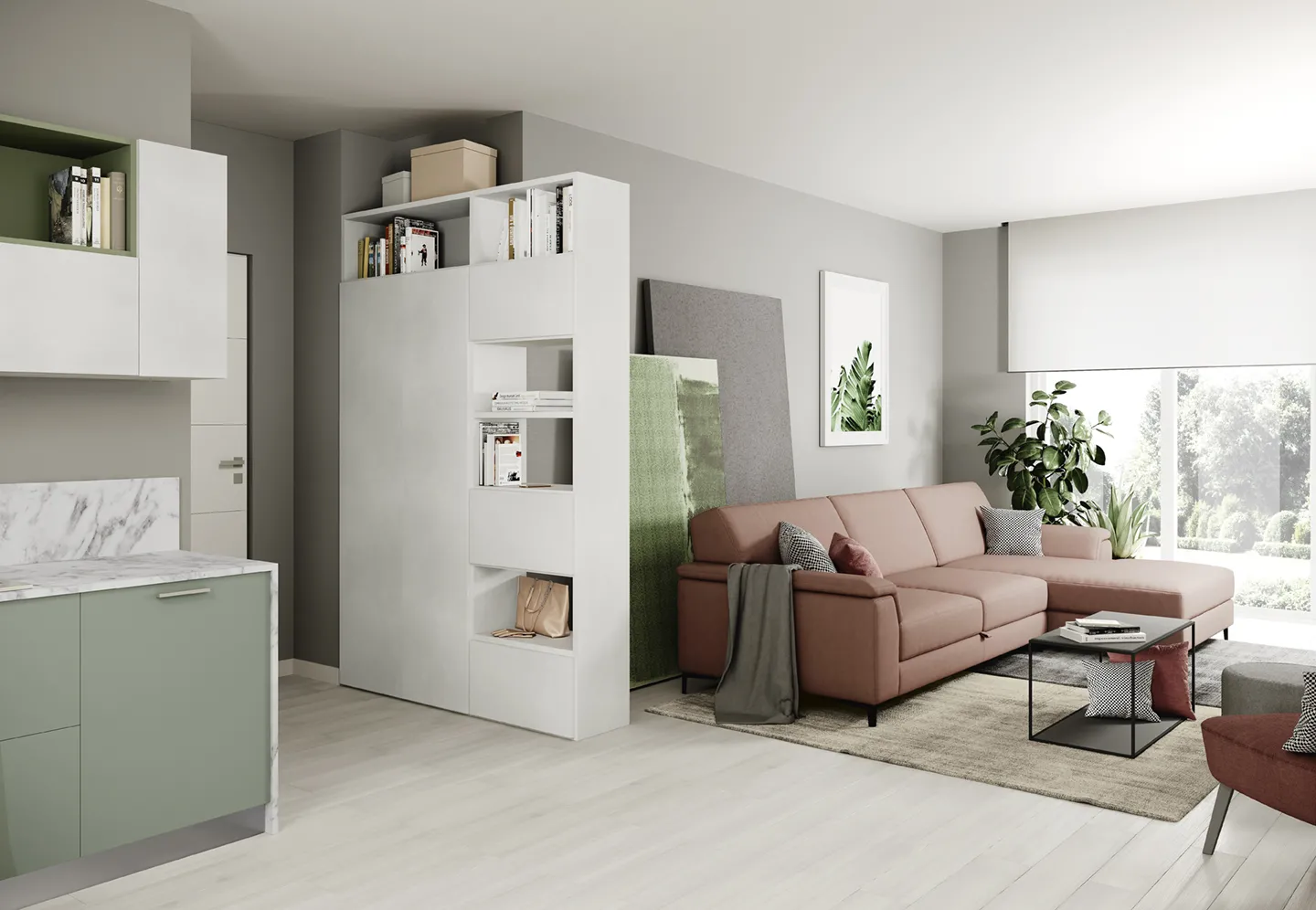 Monolocale Volo Colombini con libreria bifacciale tra divano e angolo cottura verde salvia