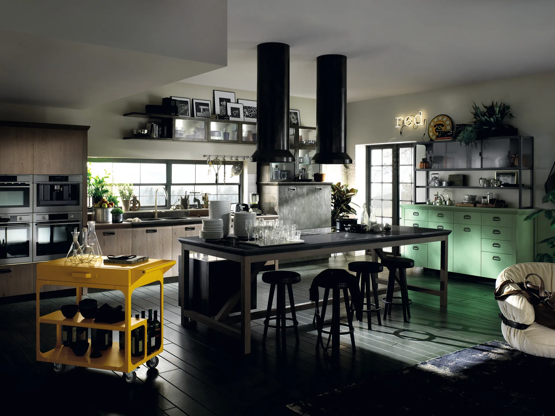 Cucina Diesel Social Kitchen Scavolini con isola, doppia cappa nera, basi verdi e carrello Misfits giallo