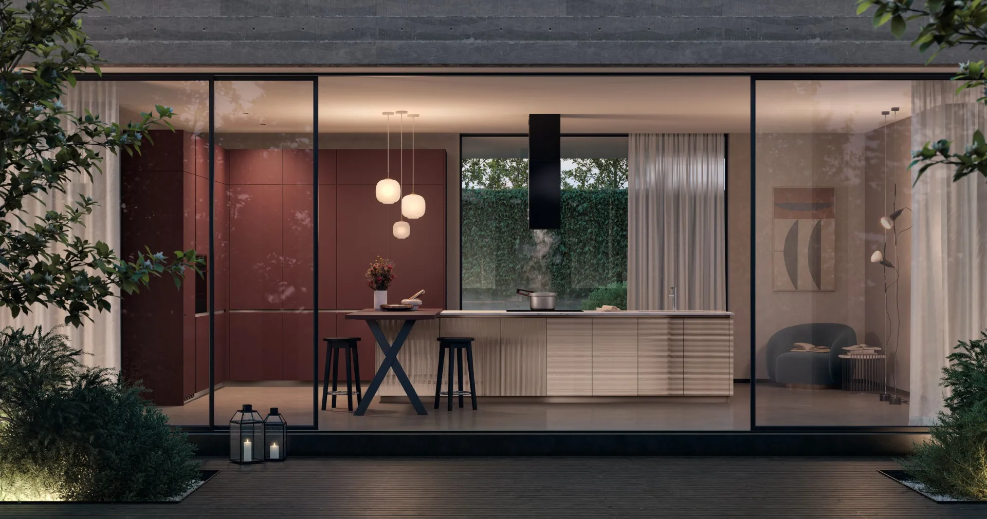 Cucina Lumina Scavolini con isola e colonne in Fenix Rosso Jaipur vista dal giardino di sera