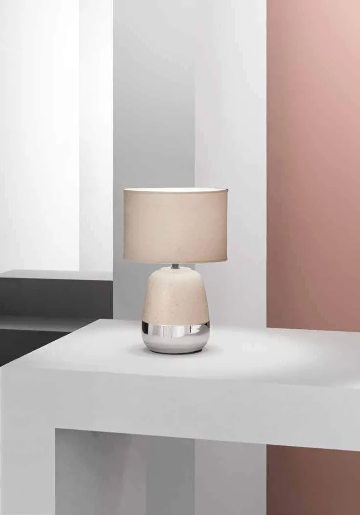 Lampada da tavolo Sioux Fan Europe con base bombata davanti a una parete rosa