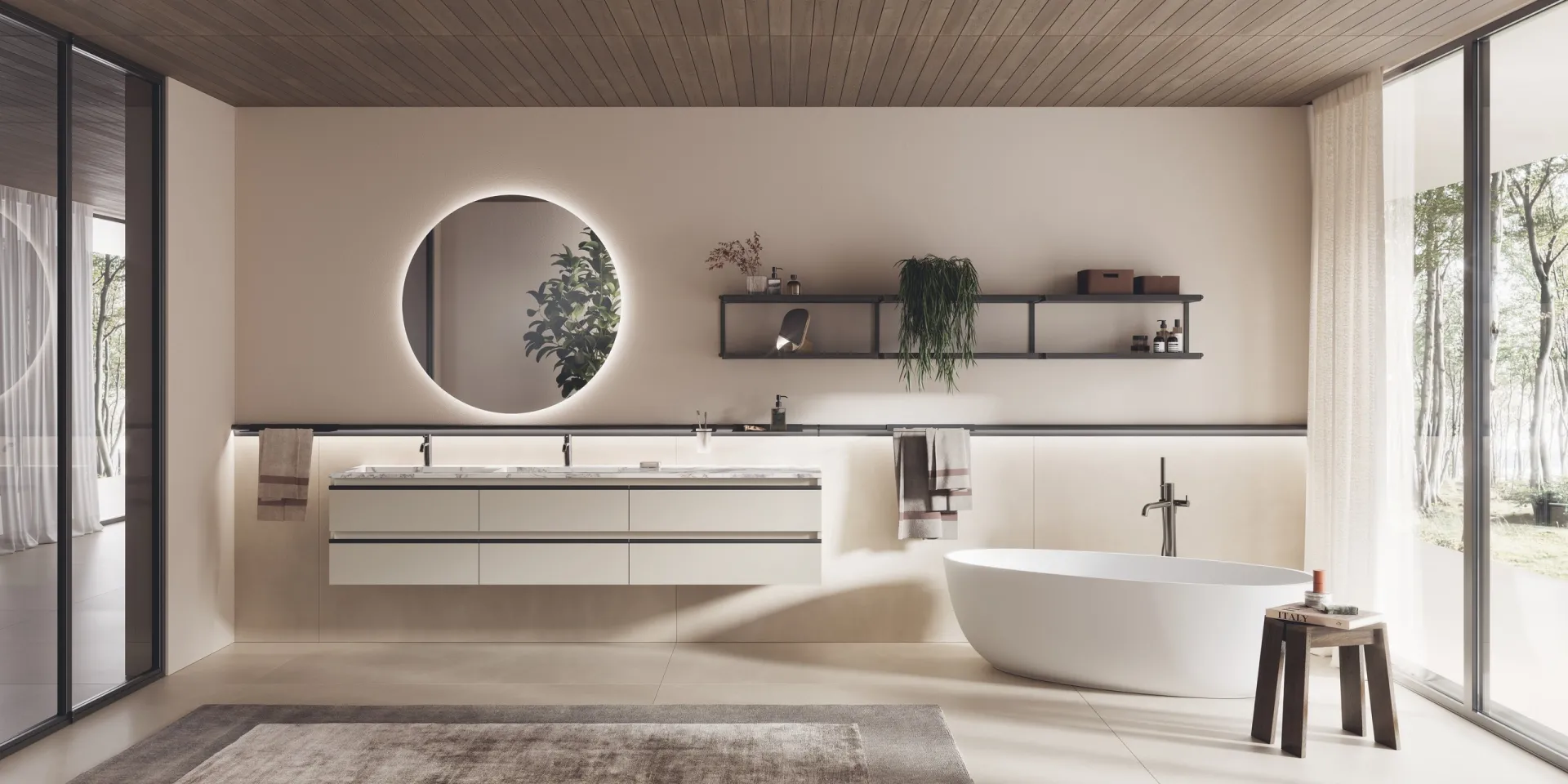 Bagno Stilo Scavolini con base sospesa bianca, specchio tondo retroilluminato e mensole su reggimensole cilindrici