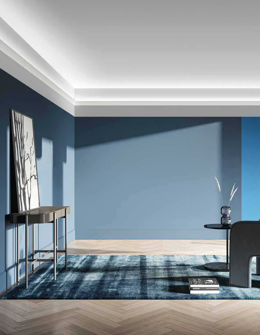 Cornice luminosa in gesso Profy Gimel Fan Europe in una stanza blu con tappeto
