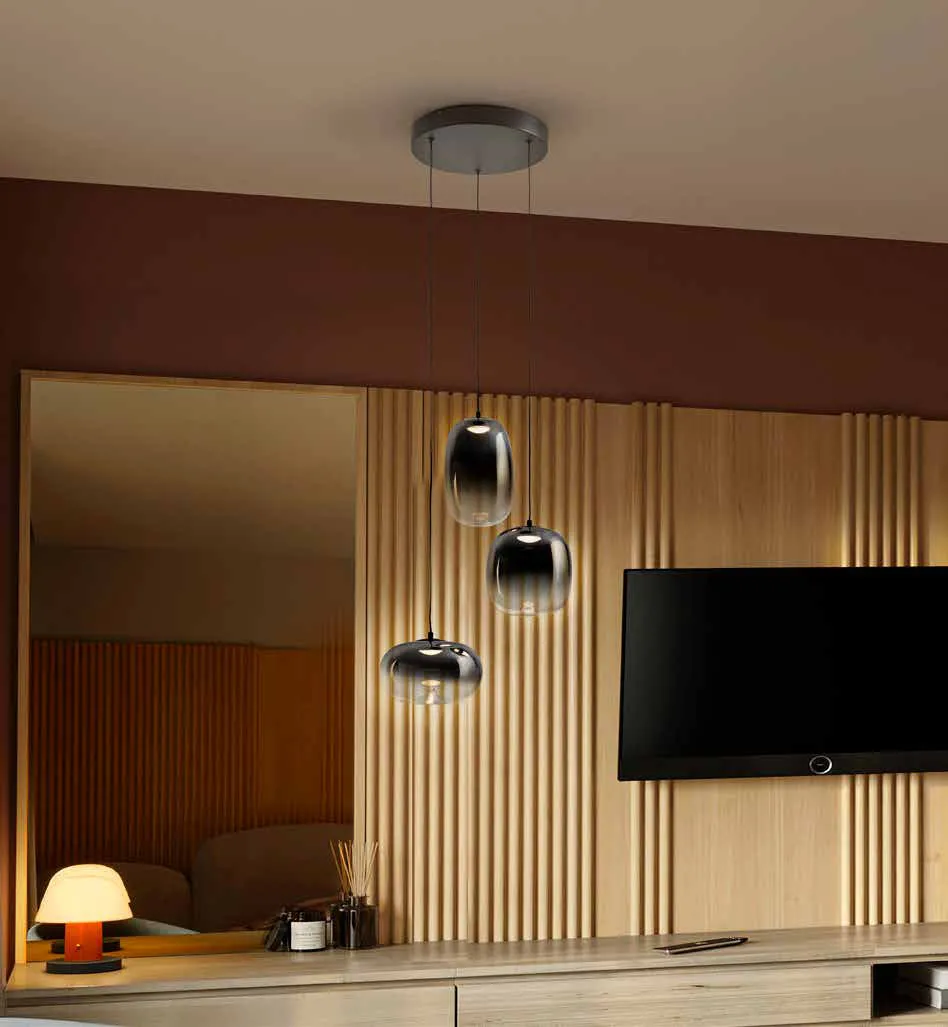 Lampada Onice Schuller a 3 luci accanto a una parete in legno