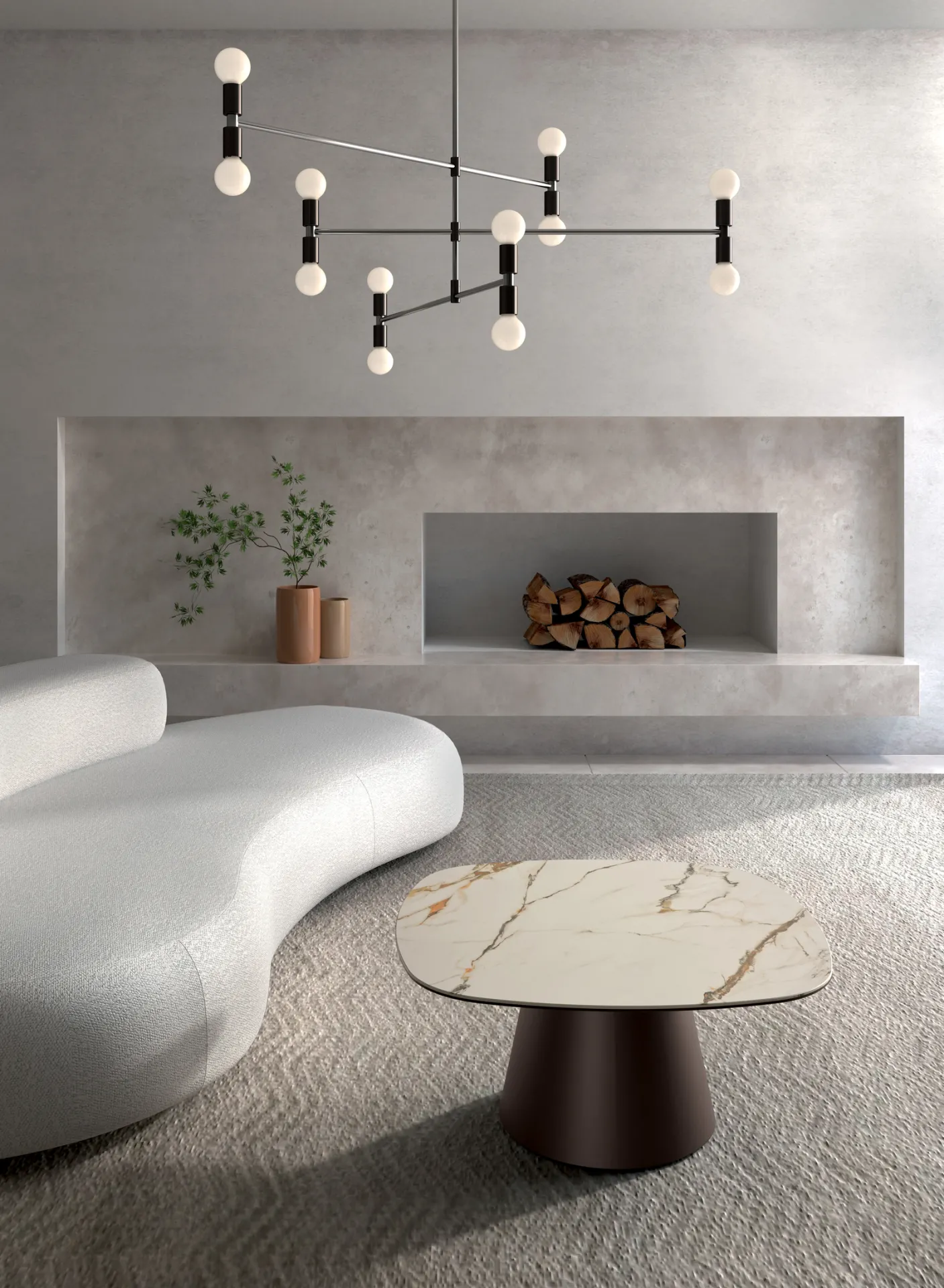 Tavolino Pillar grande Stones Calacatta Borghini con base bronzo davanti a un divano curvo