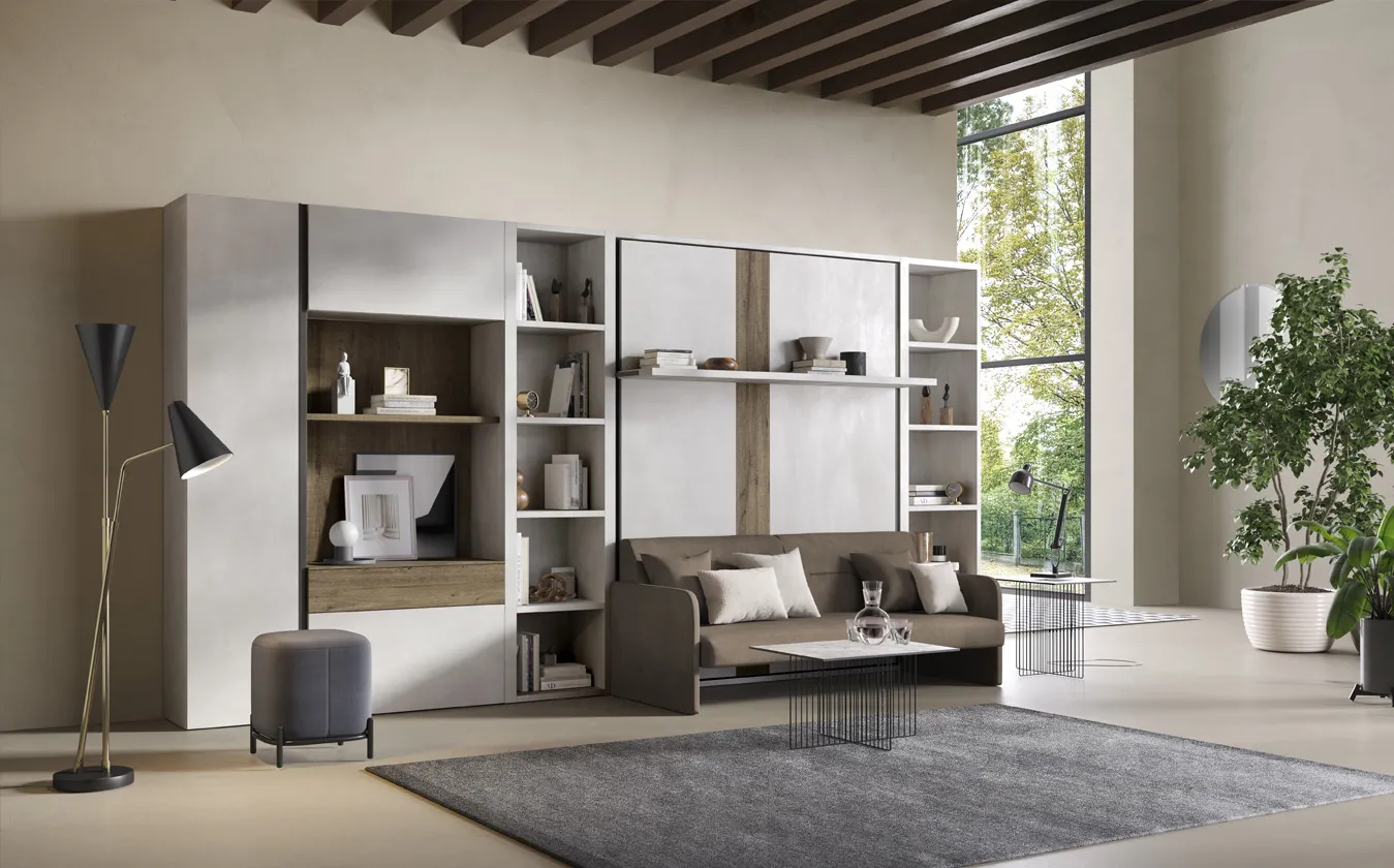 Divano Just 2B Italia con letto a scomparsa in una parete con librerie