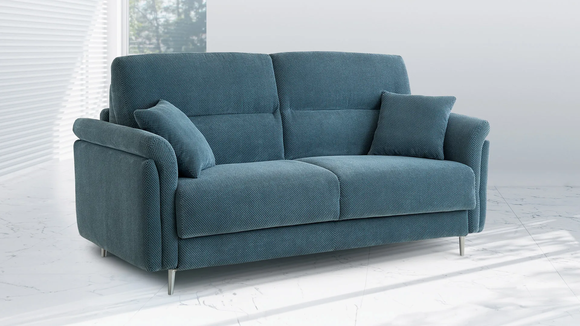Divano letto Celia Aerre Divani blu petrolio con cuscini in un ambiente chiaro e luminoso