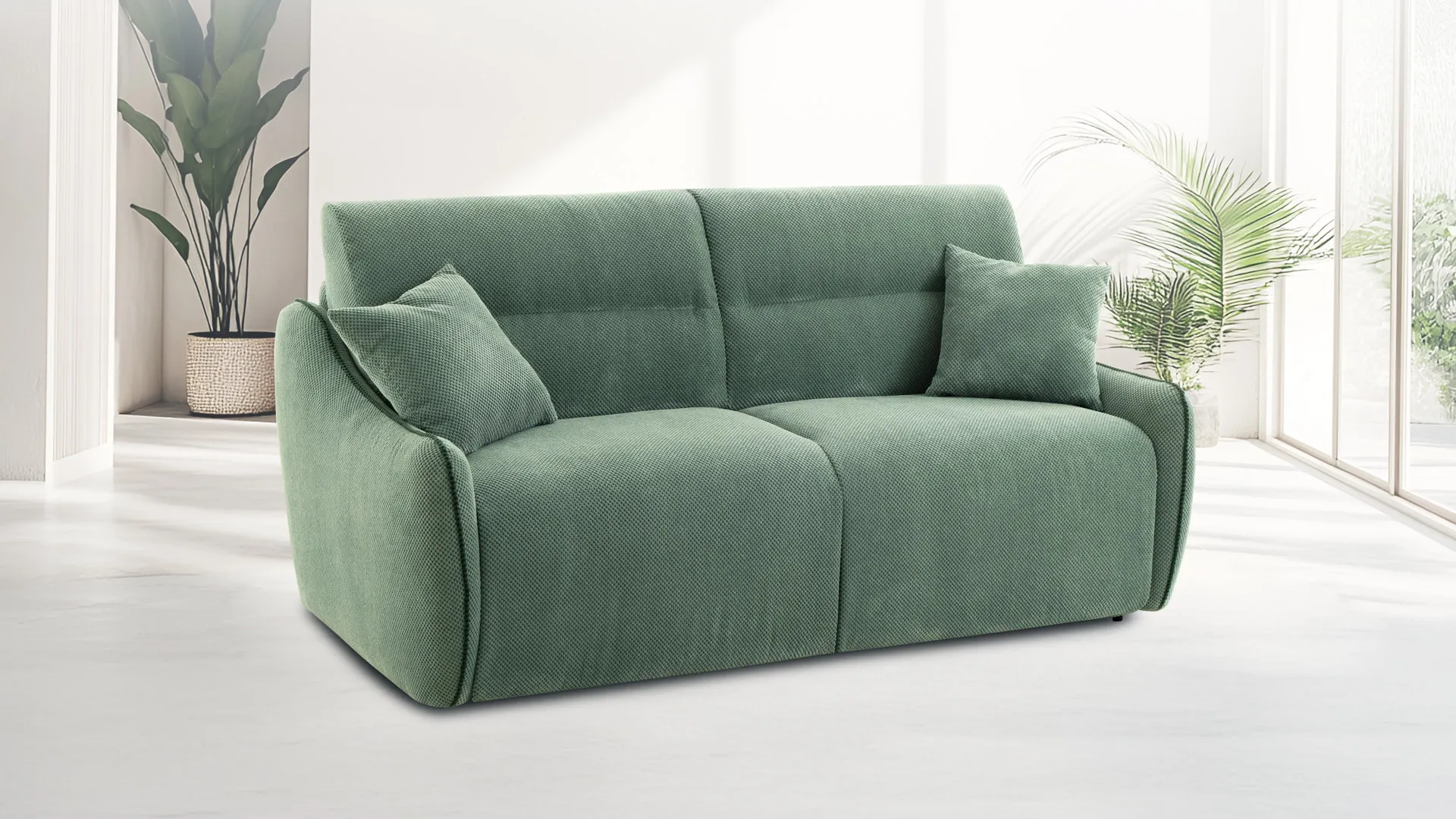 Divano letto Cherry Aerre Divani verde salvia con cuscini in una stanza luminosa con piante