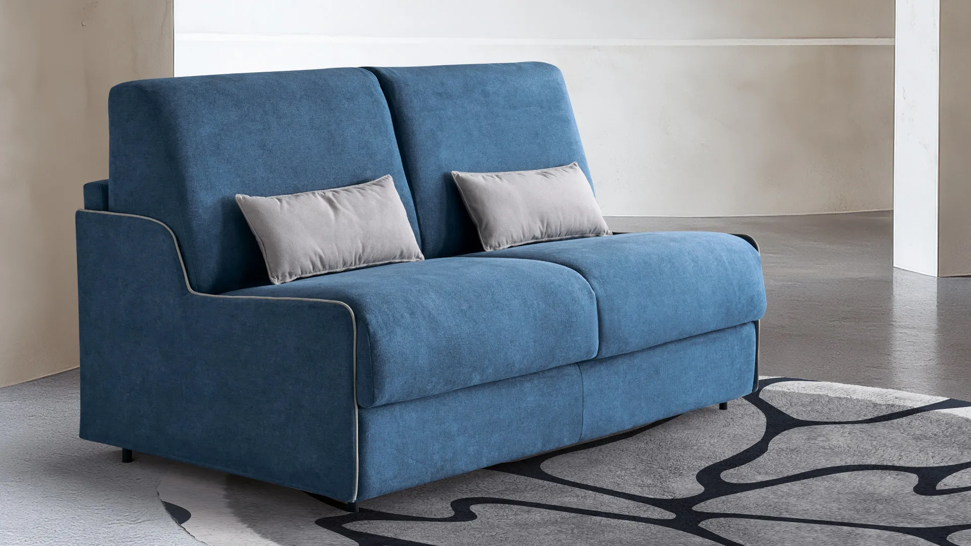 Divano letto Slim Aerre Divani blu con bordino bianco su tappeto a disegni