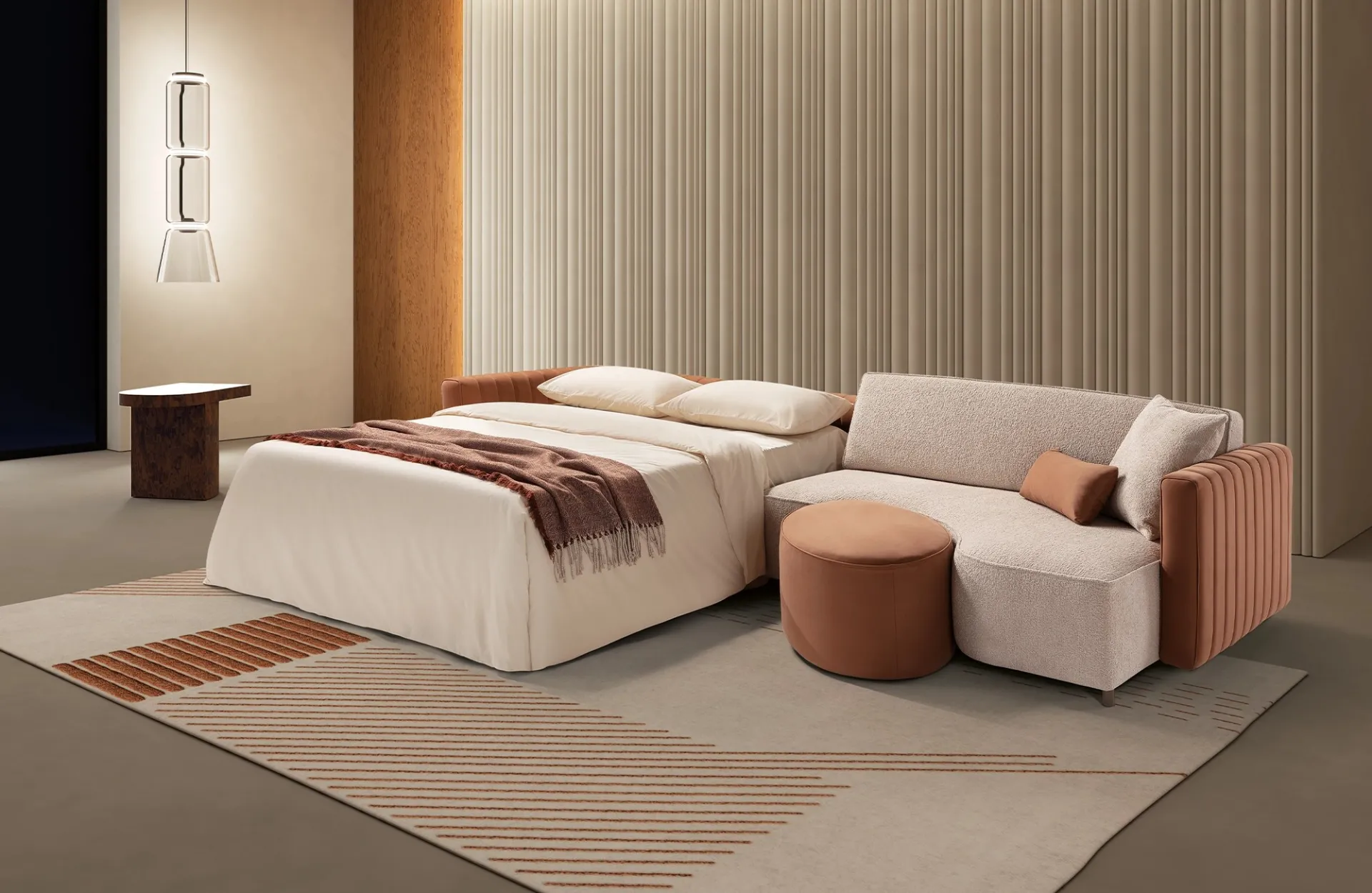 Divano letto Lake Dienne aperto di sera, con il terminale e il pouf accanto al letto