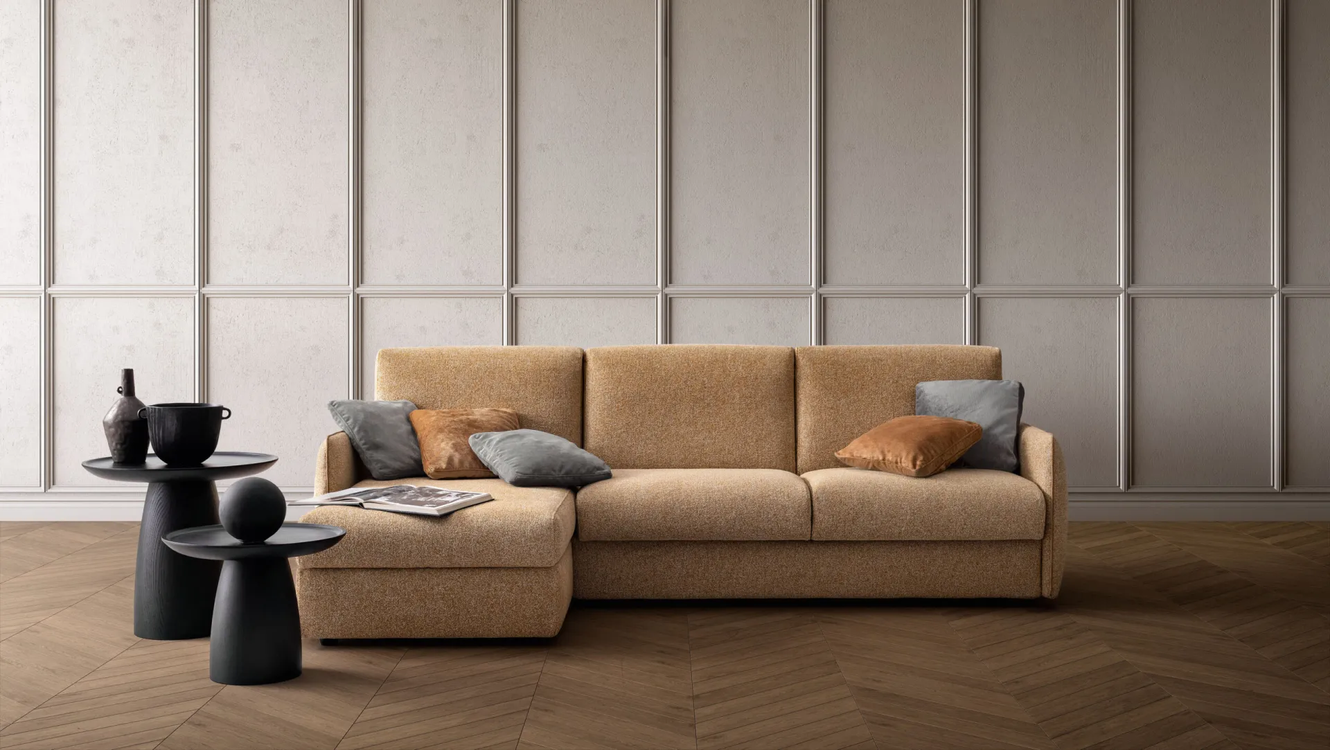 Divano letto Wonder Samoa color ocra con penisola e braccioli sottili, davanti a una boiserie chiara